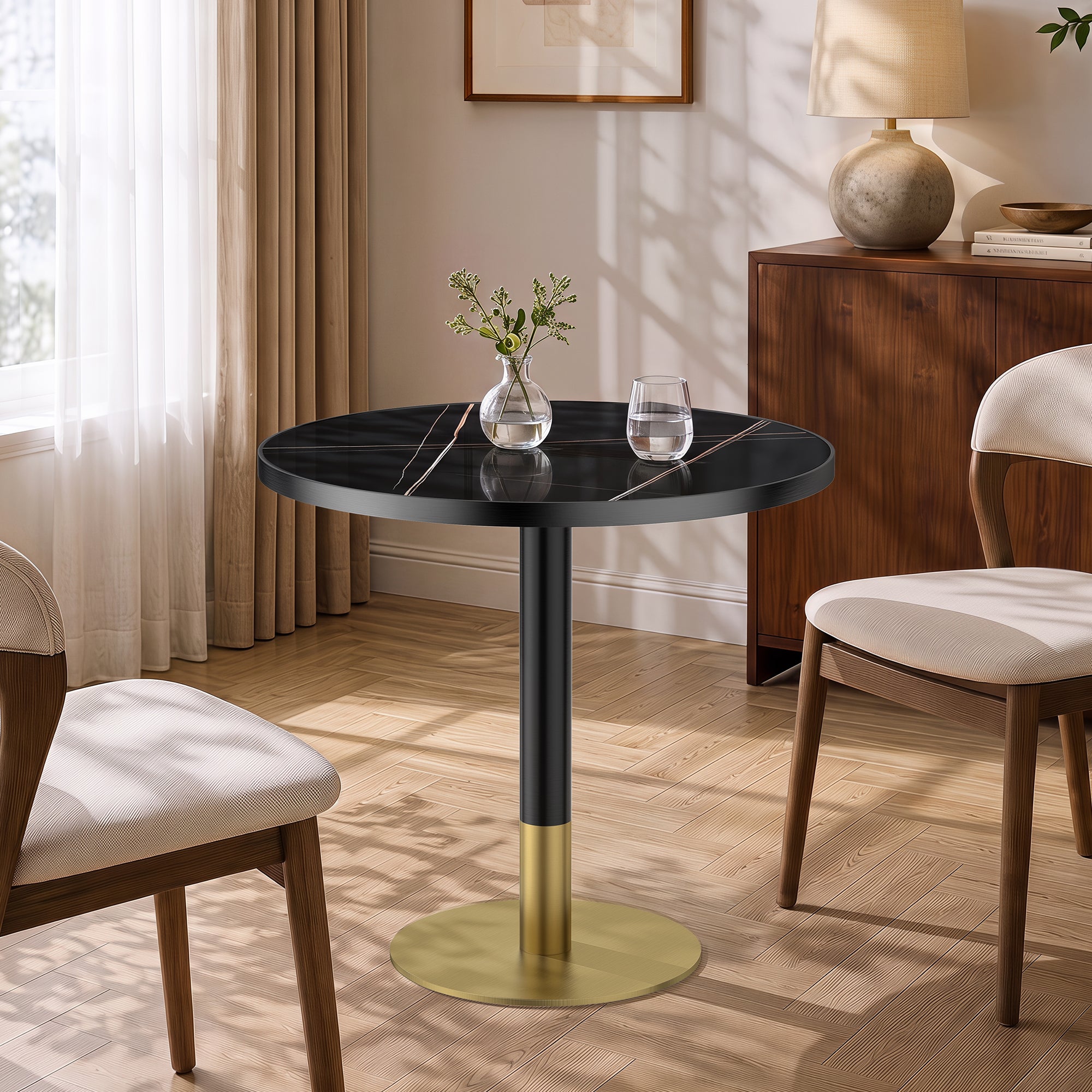 Dining nook setting with the black sintered stone round table, vase and water glass on wood floor