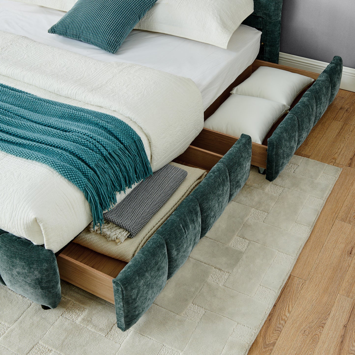 Angled view of open wood drawer with wood slat mattress support