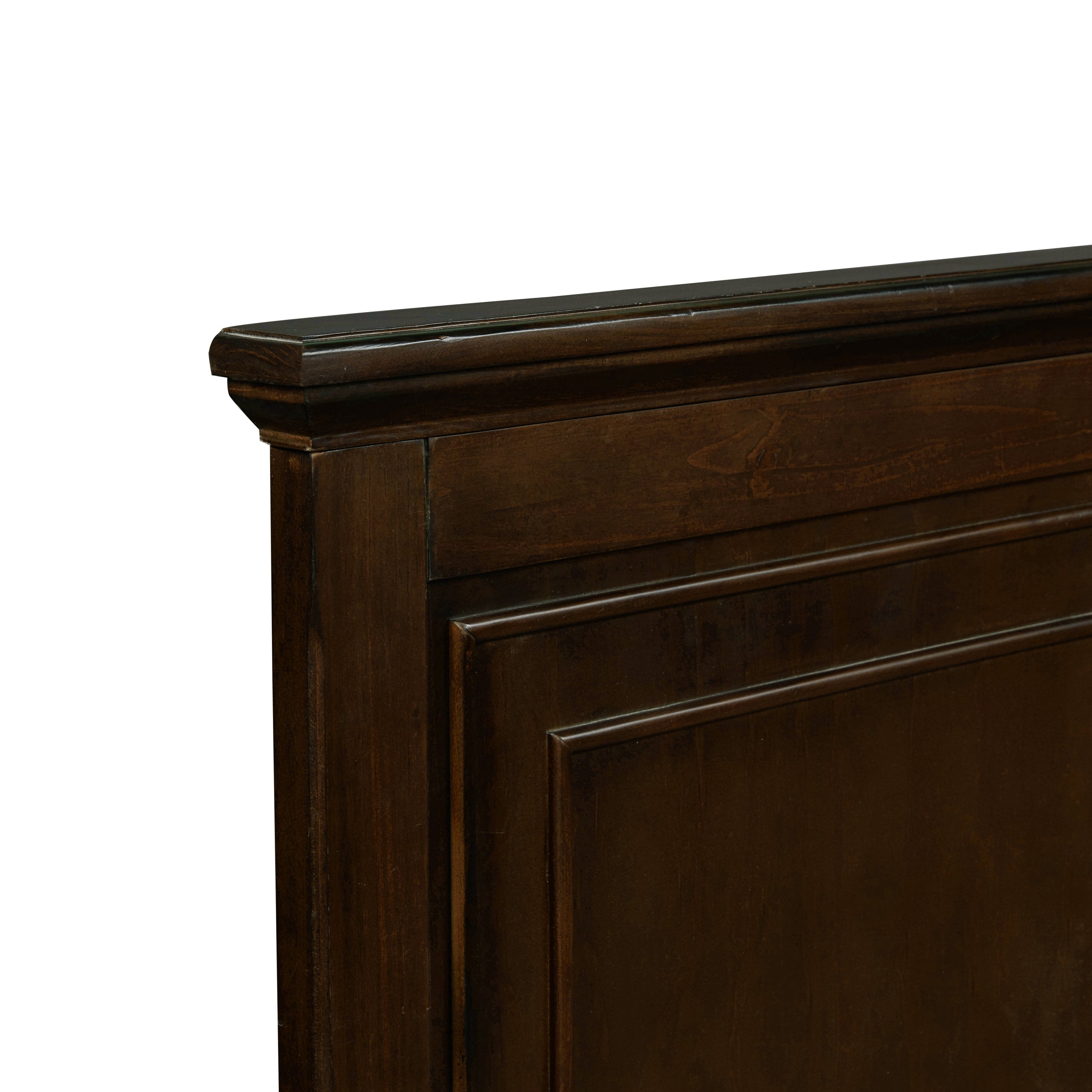 Close-up of the headboard top corner and beveled molding on the rich brown queen bed