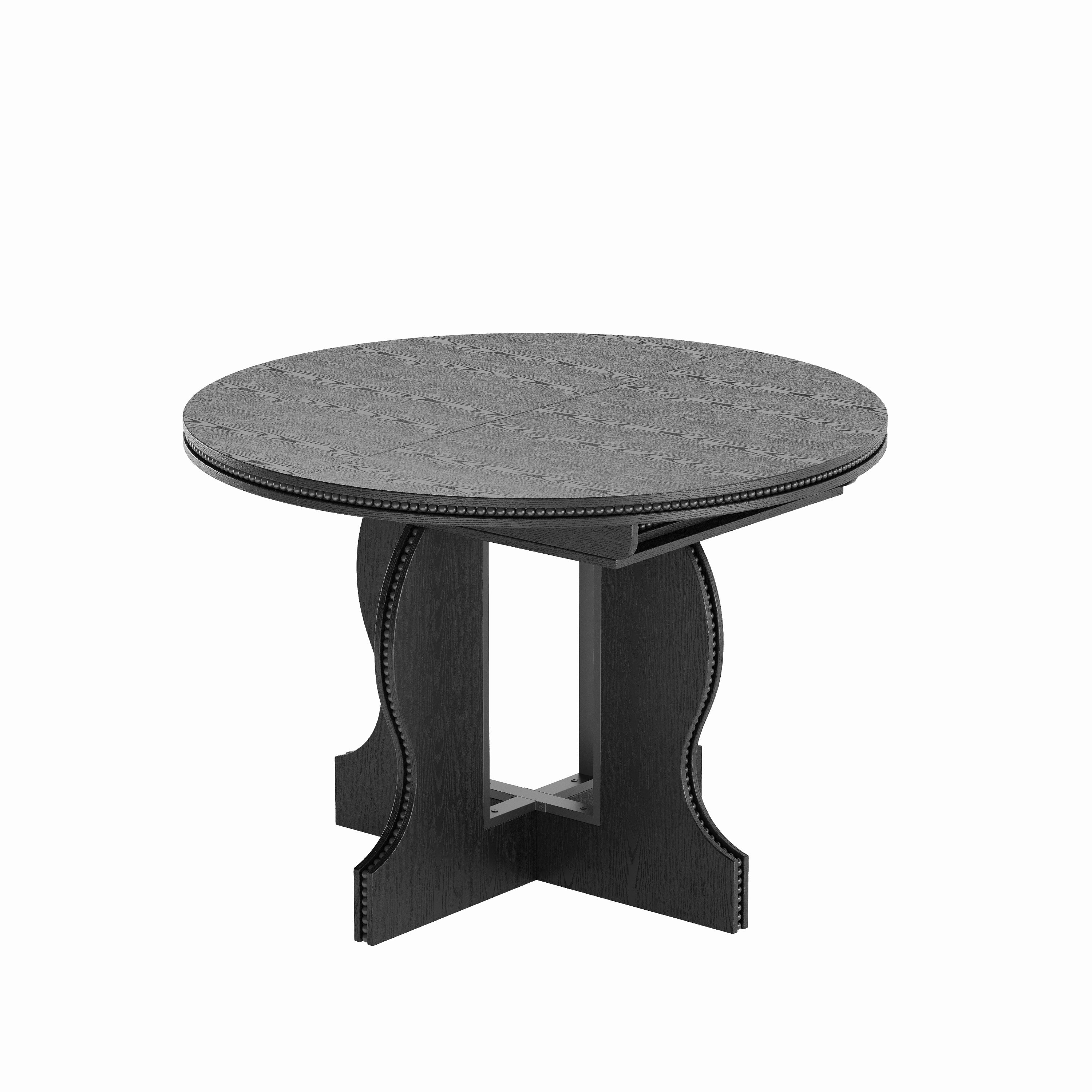 Black round dining table viewed from a high angle on a plain white studio background