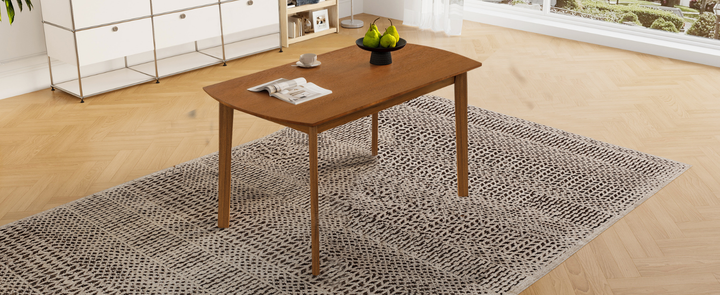 High angled view of the brown dining table with pears and magazine on a patterned rug