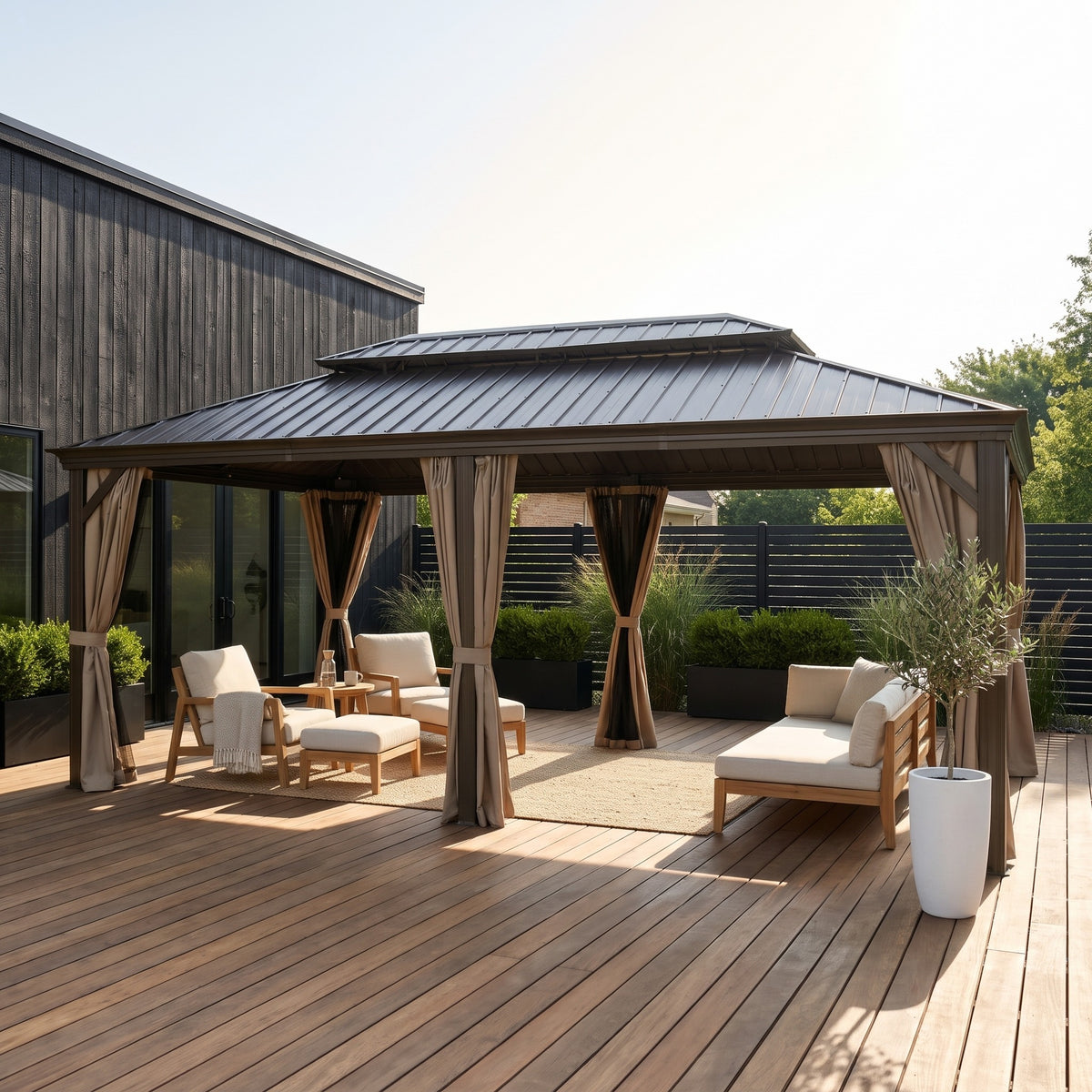 Brown aluminum 12x20 double roof hardtop gazebo with tied back curtains over lounge seating on a wood deck