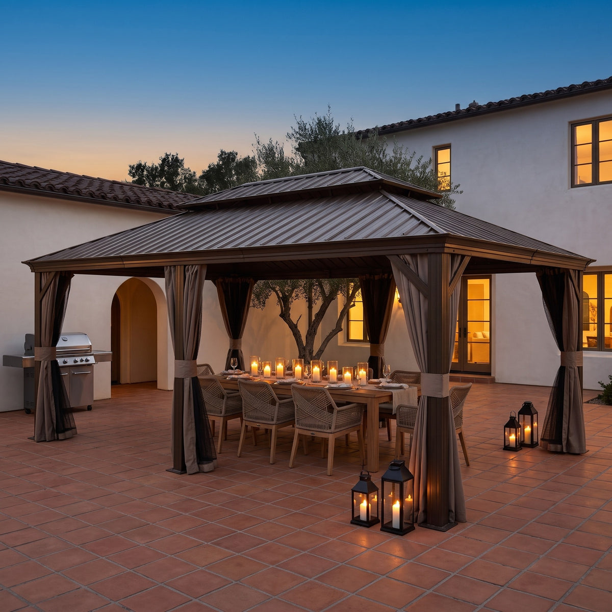 Brown aluminum 14x24 double roof hardtop gazebo over a candlelit dining table on a terracotta patio at dusk