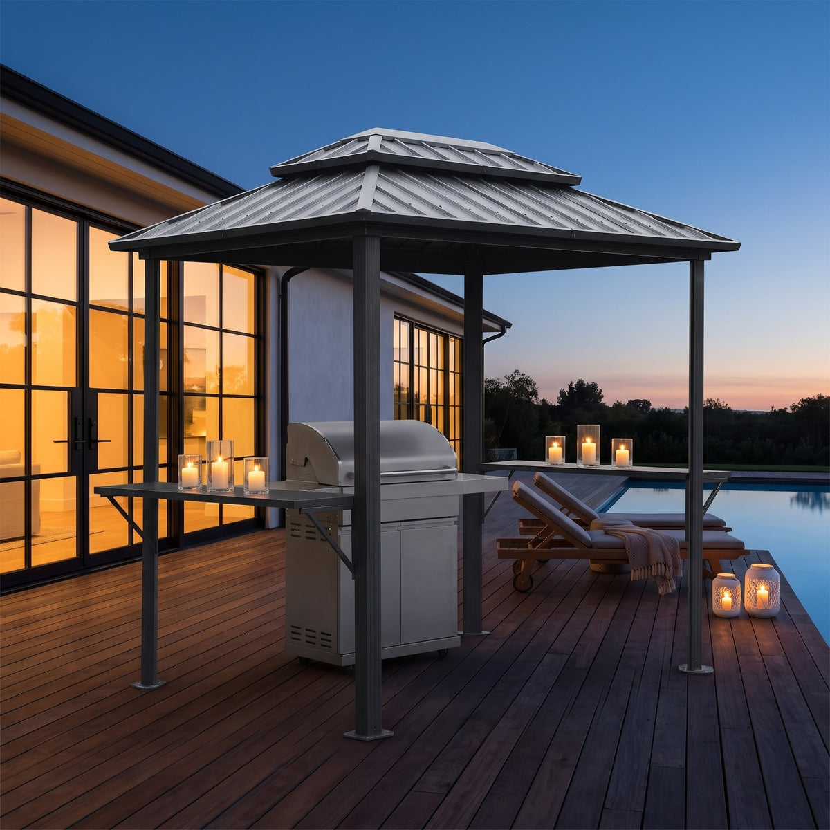 Gray metal 6x8 double roof grill gazebo with side shelves over a grill on a poolside deck at dusk with candles