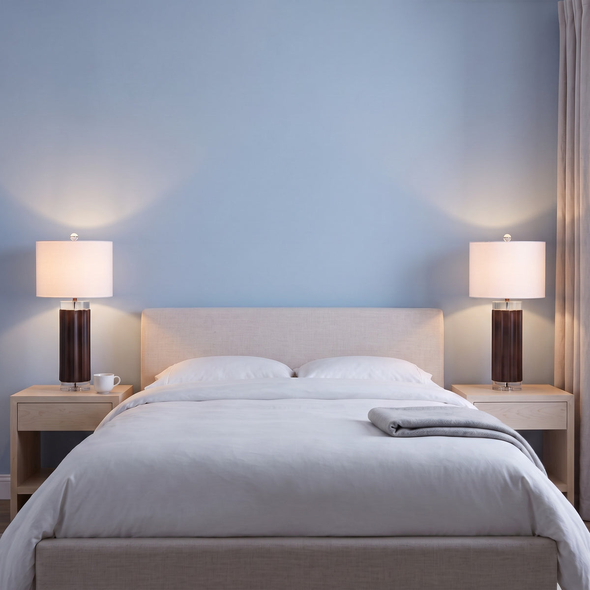 Pair of brown fluted table lamps with crystal accents and white drum shades, lit on nightstands beside a bed