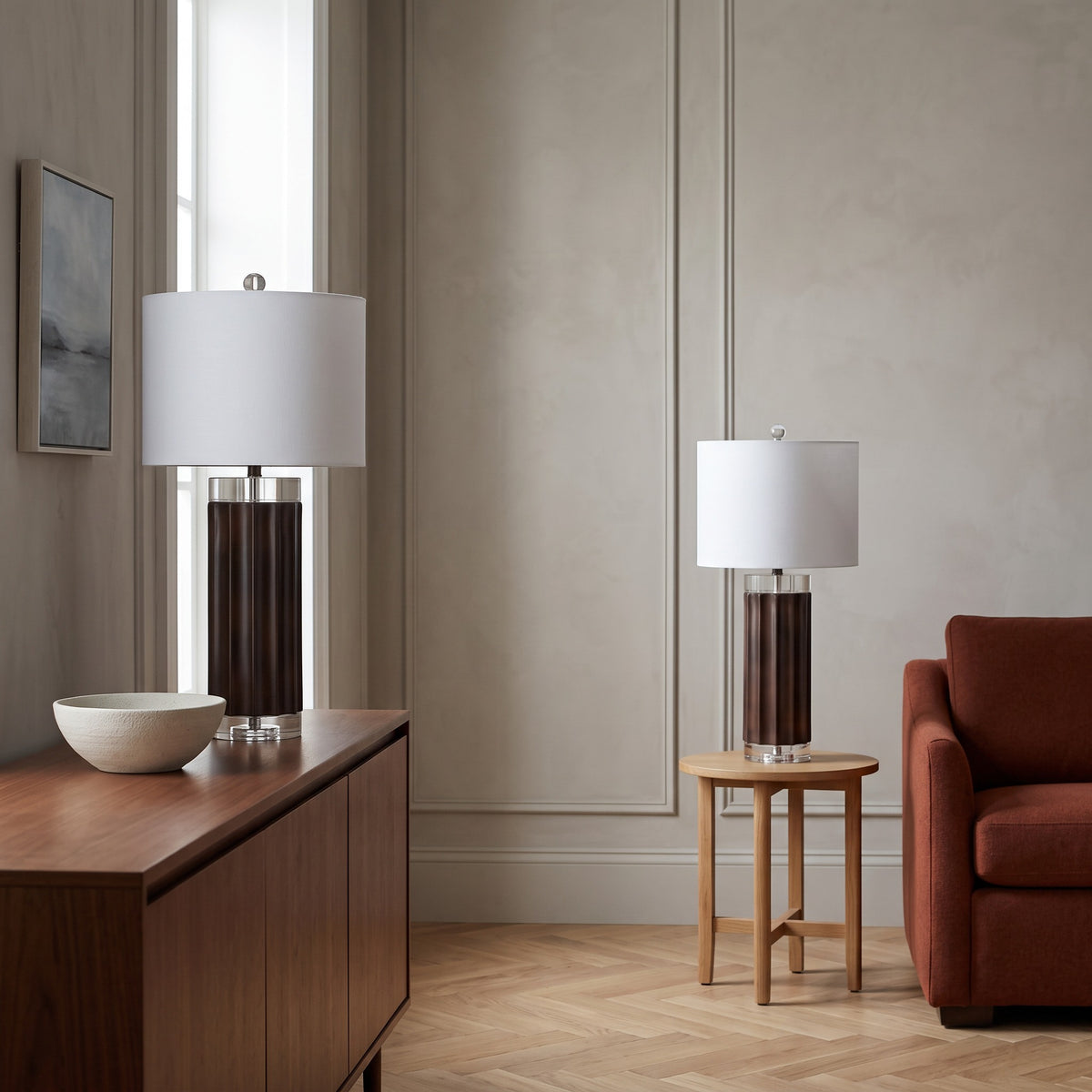 Pair of brown fluted table lamps with crystal accents and white linen shades on a walnut sideboard and oak side table