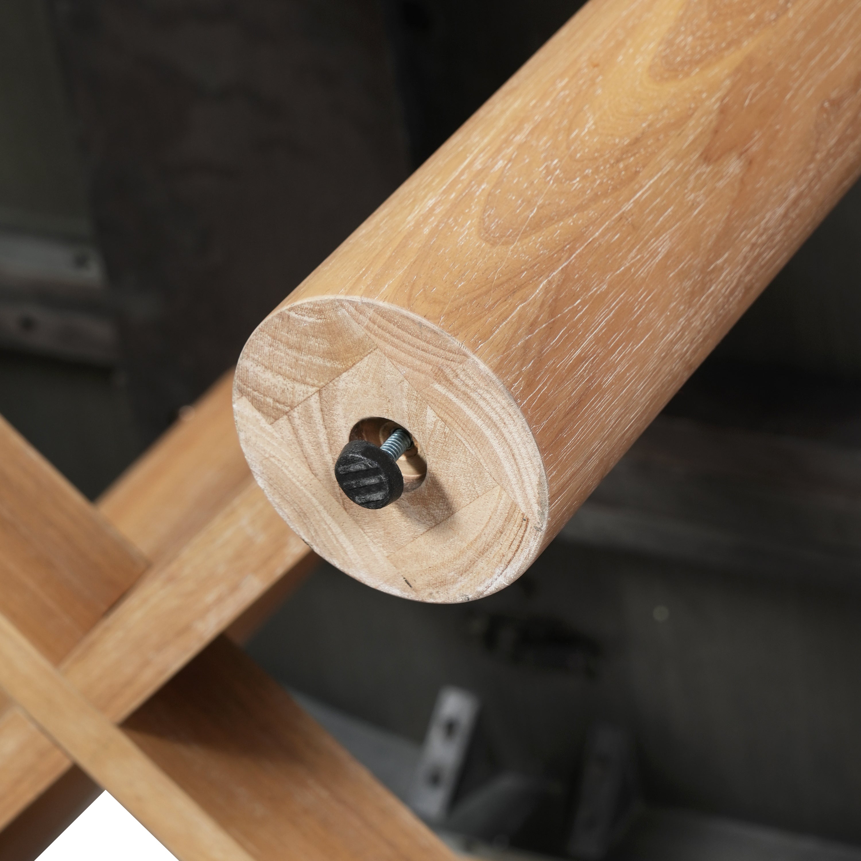 Close-up of a leg end underside showing the black-capped mounting bolt