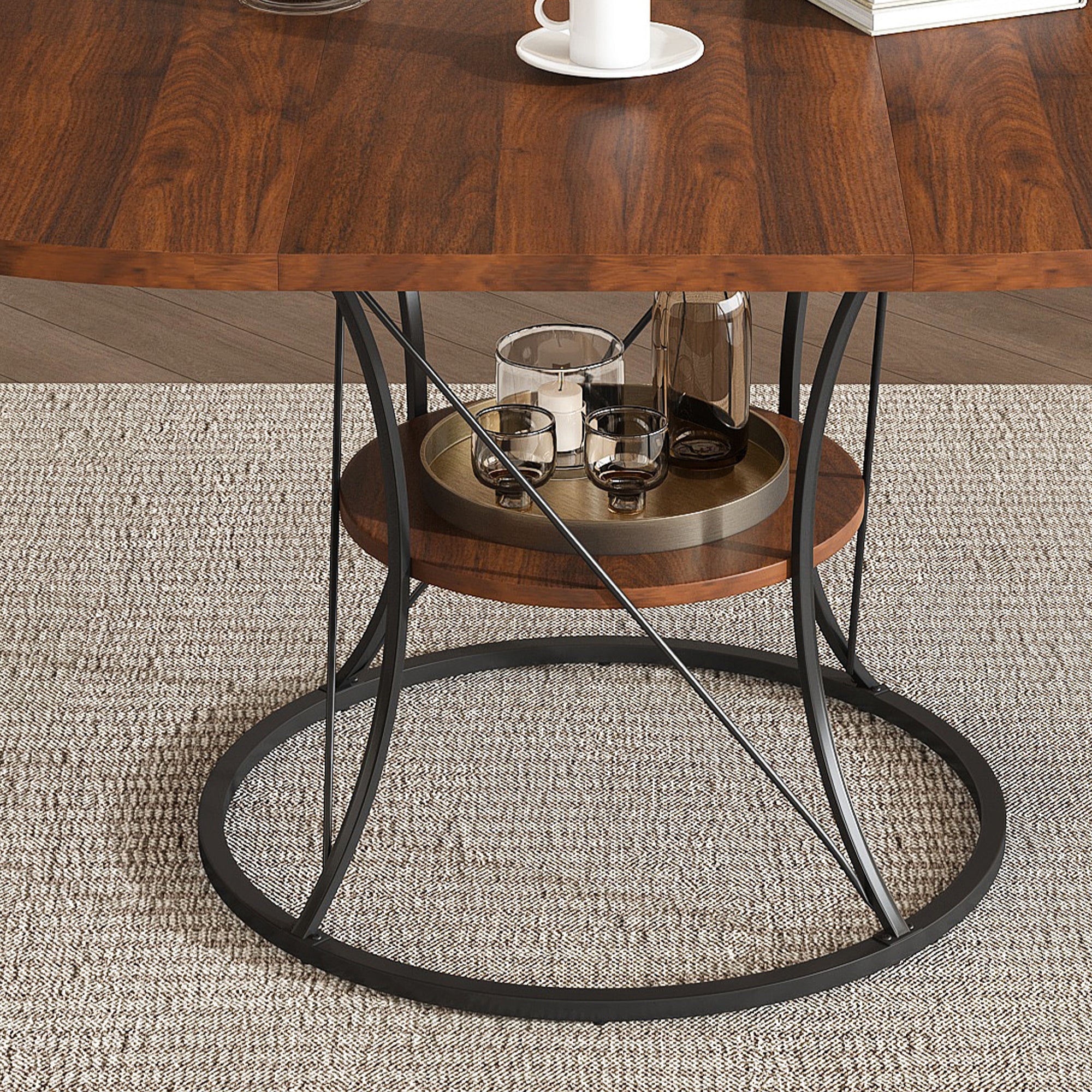 Close-up of the black iron cage base and round walnut storage shelf holding glasses and a tray