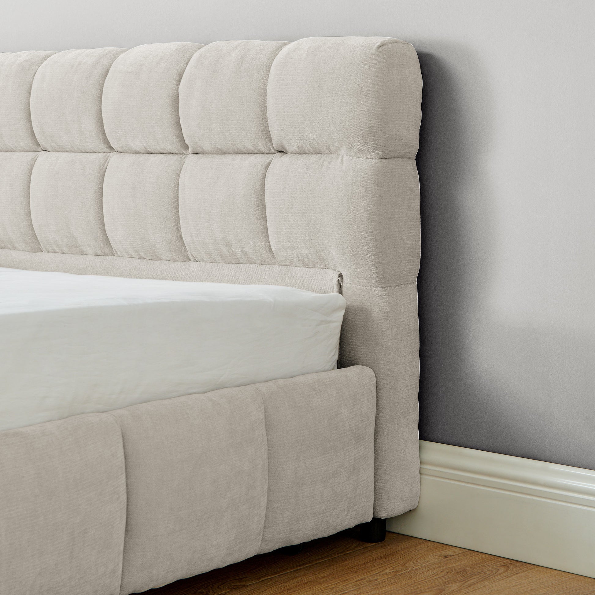 Open underbed storage drawer with folded throw and pillow inside