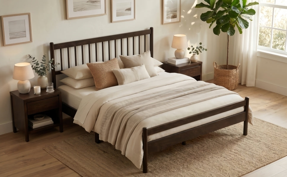 Brown pine queen bed frame at an angle in a sunlit bedroom with a nightstand, lamp and tall plant #Color_Brown