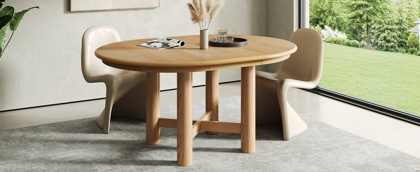 Three-quarter view of the round oak table with a single cream boucle chair