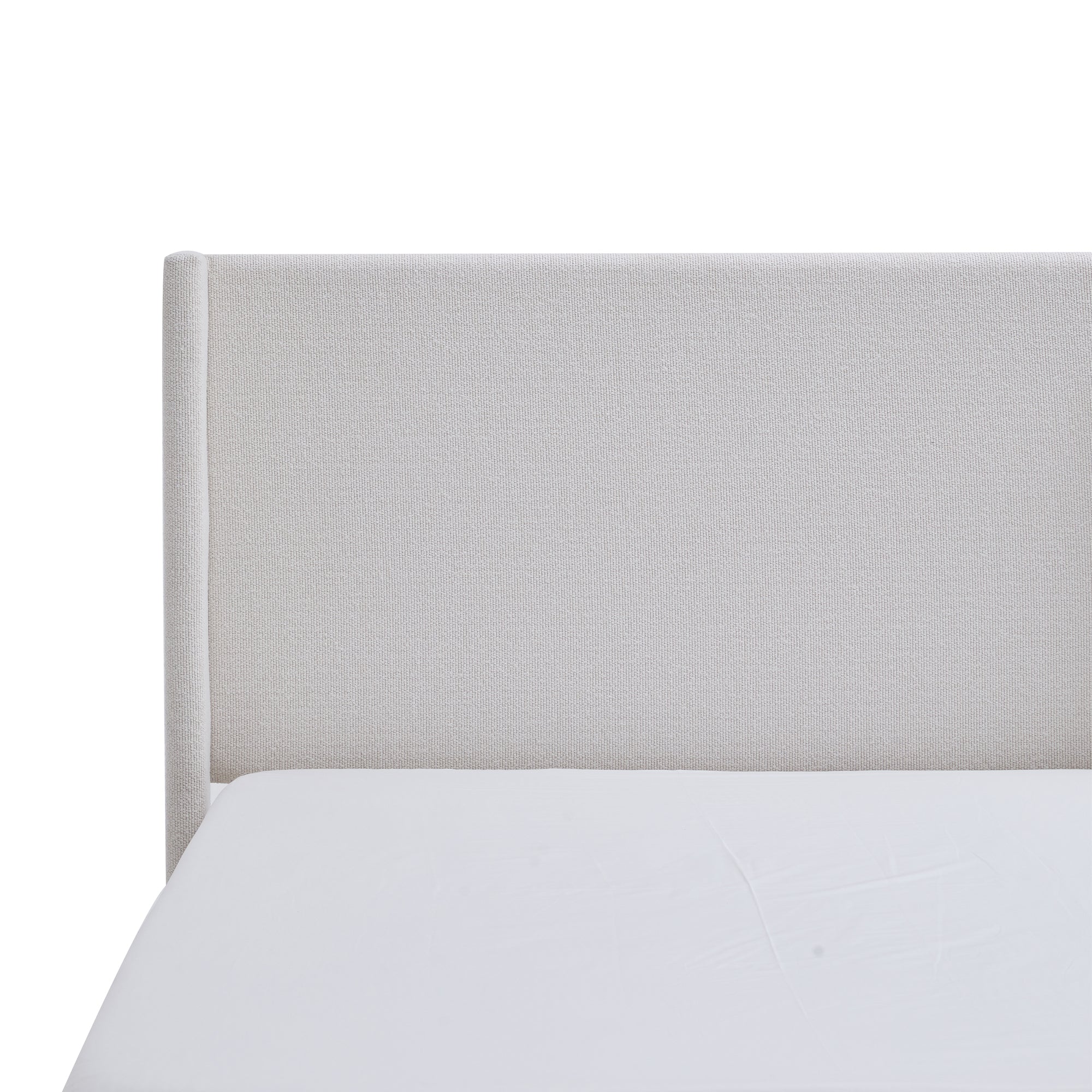 Lifestyle shot of cream wingback bed with knit throw blanket