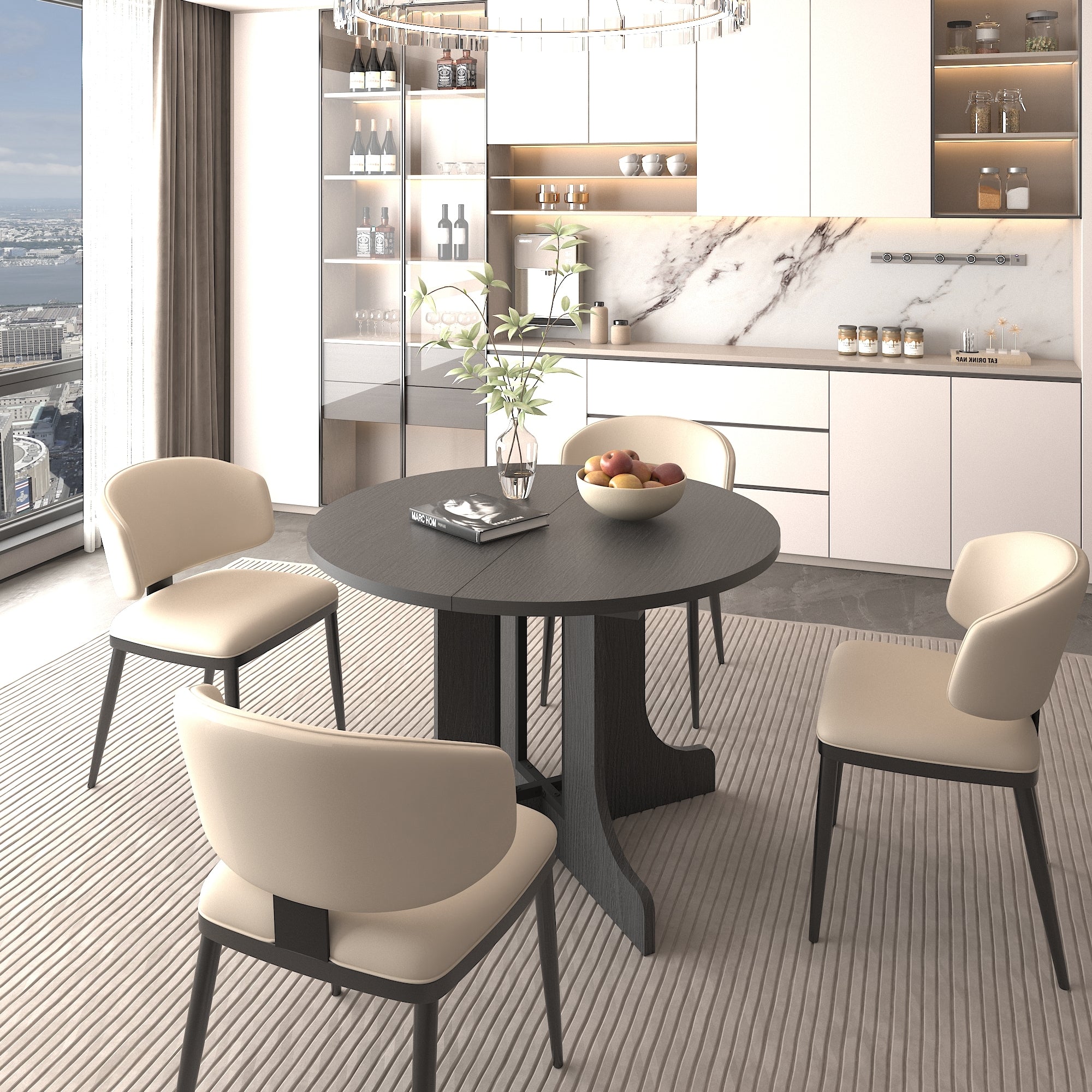 Round black dining table with cream leather chairs in a modern kitchen, fruit bowl on top