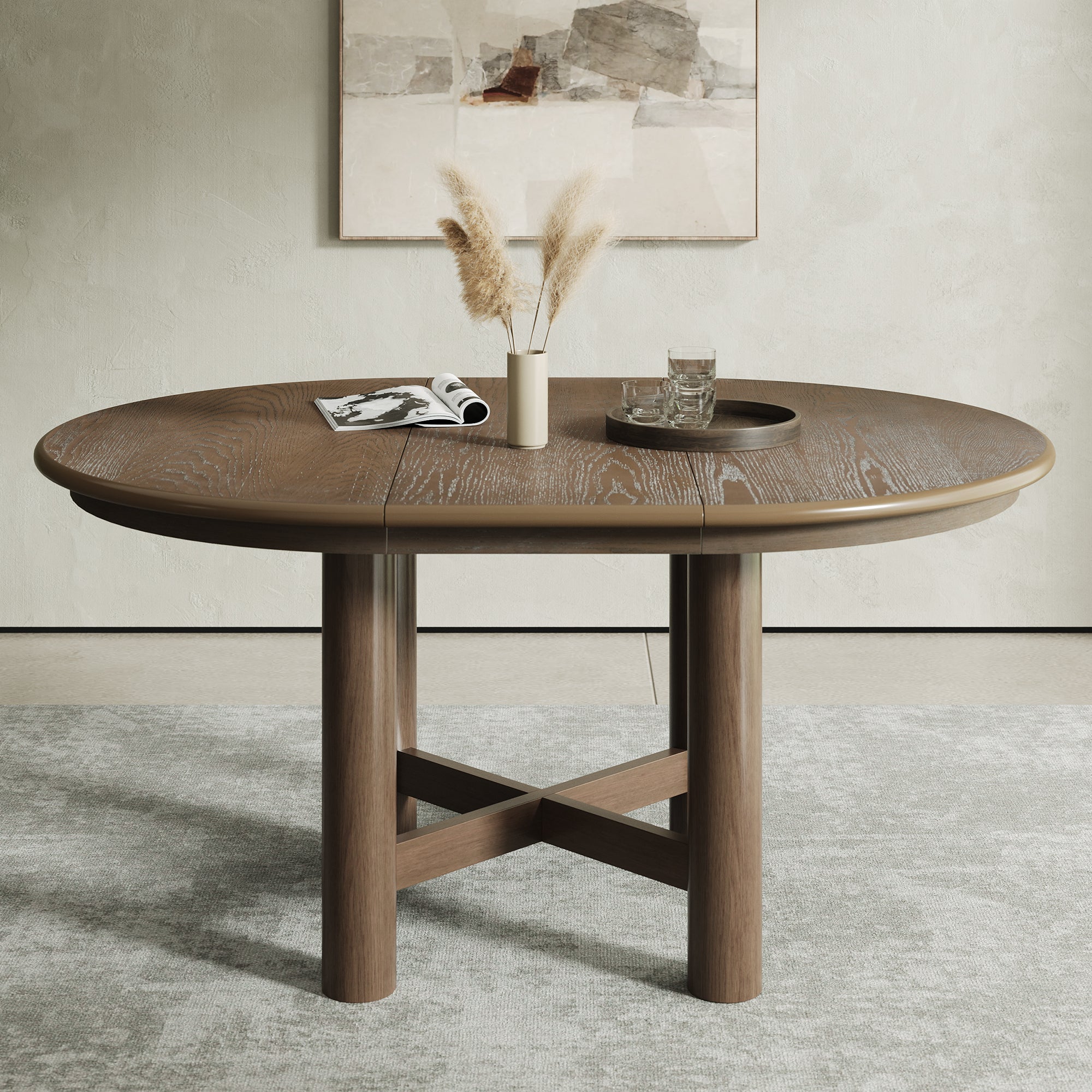 Warm brown oval extendable oak table extended, styled with pampas and a tray below abstract art