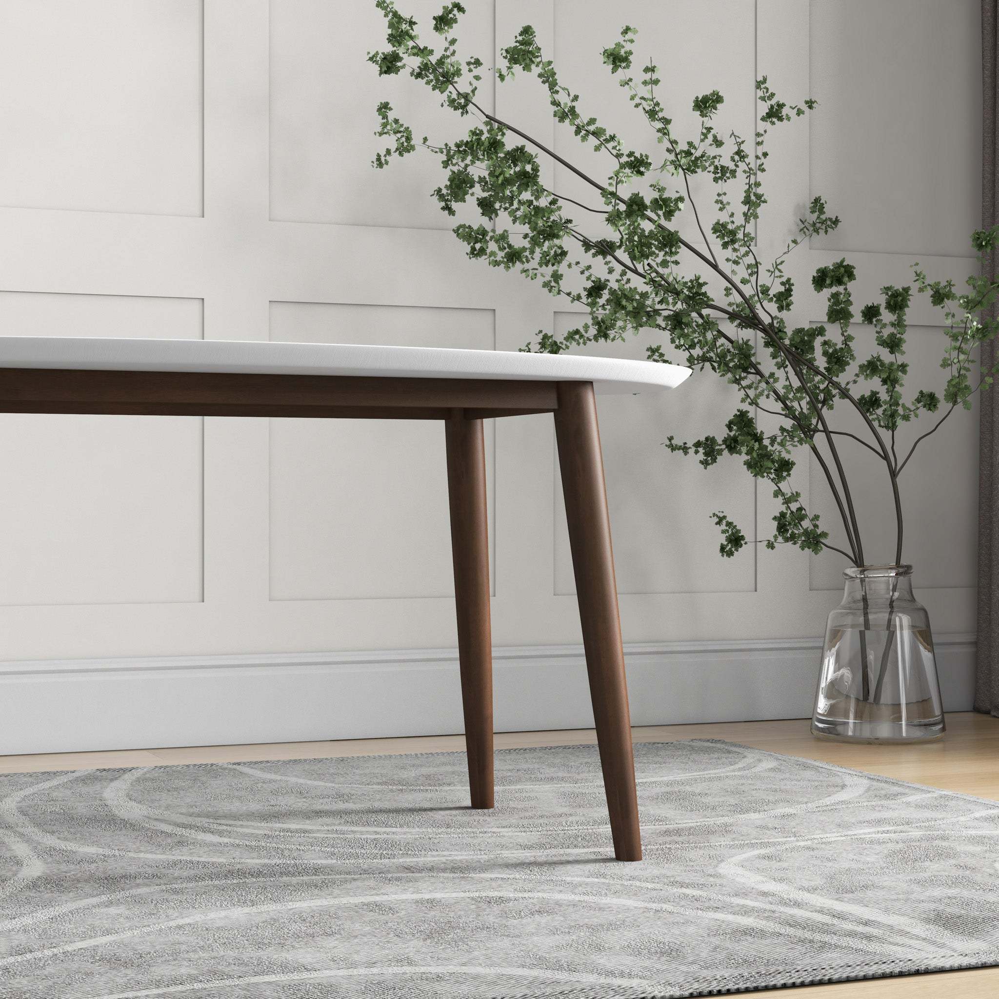 Overhead angled view of the white oval table styled with curtains and a plant