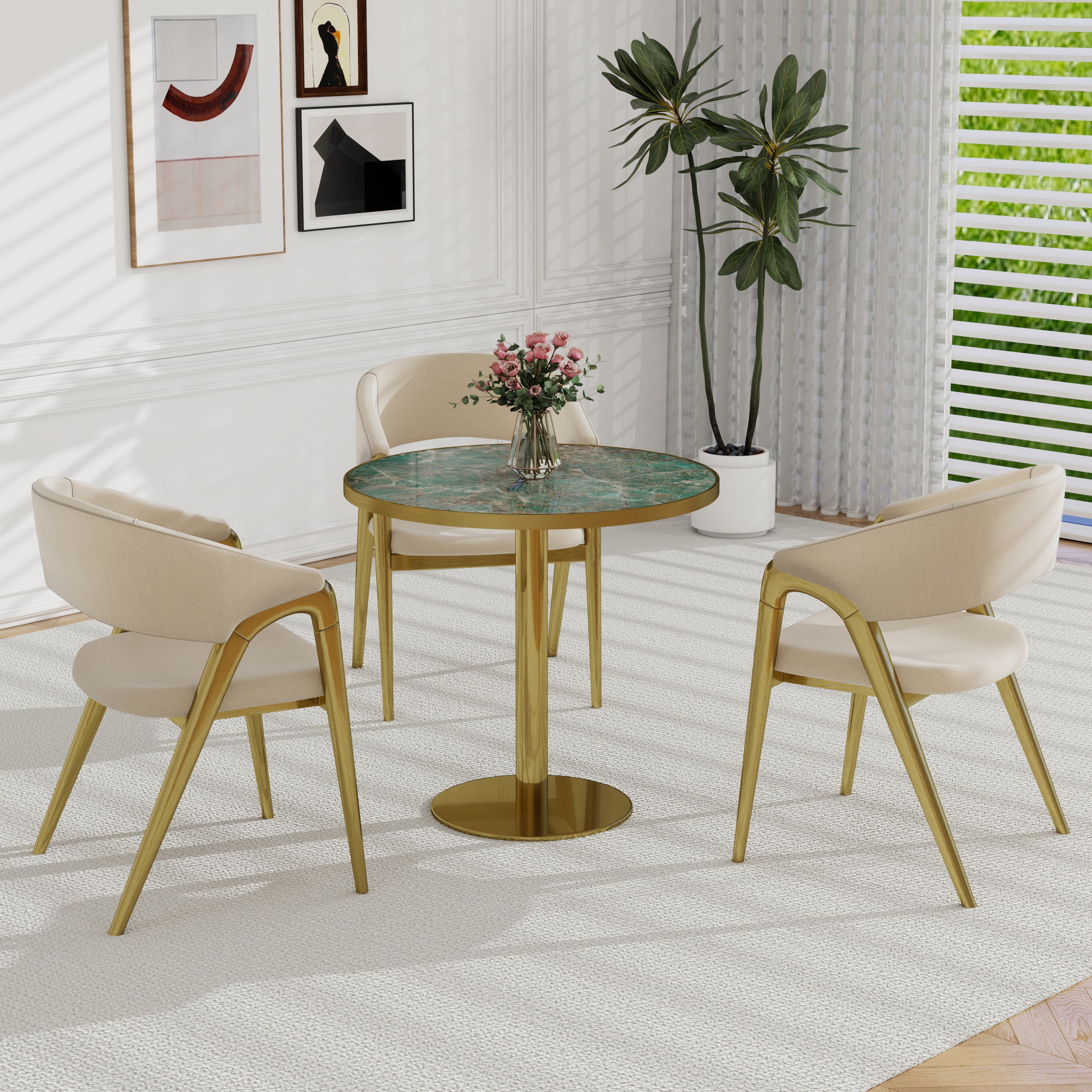Green sintered stone round dining table in styled room with cream chairs and pink roses