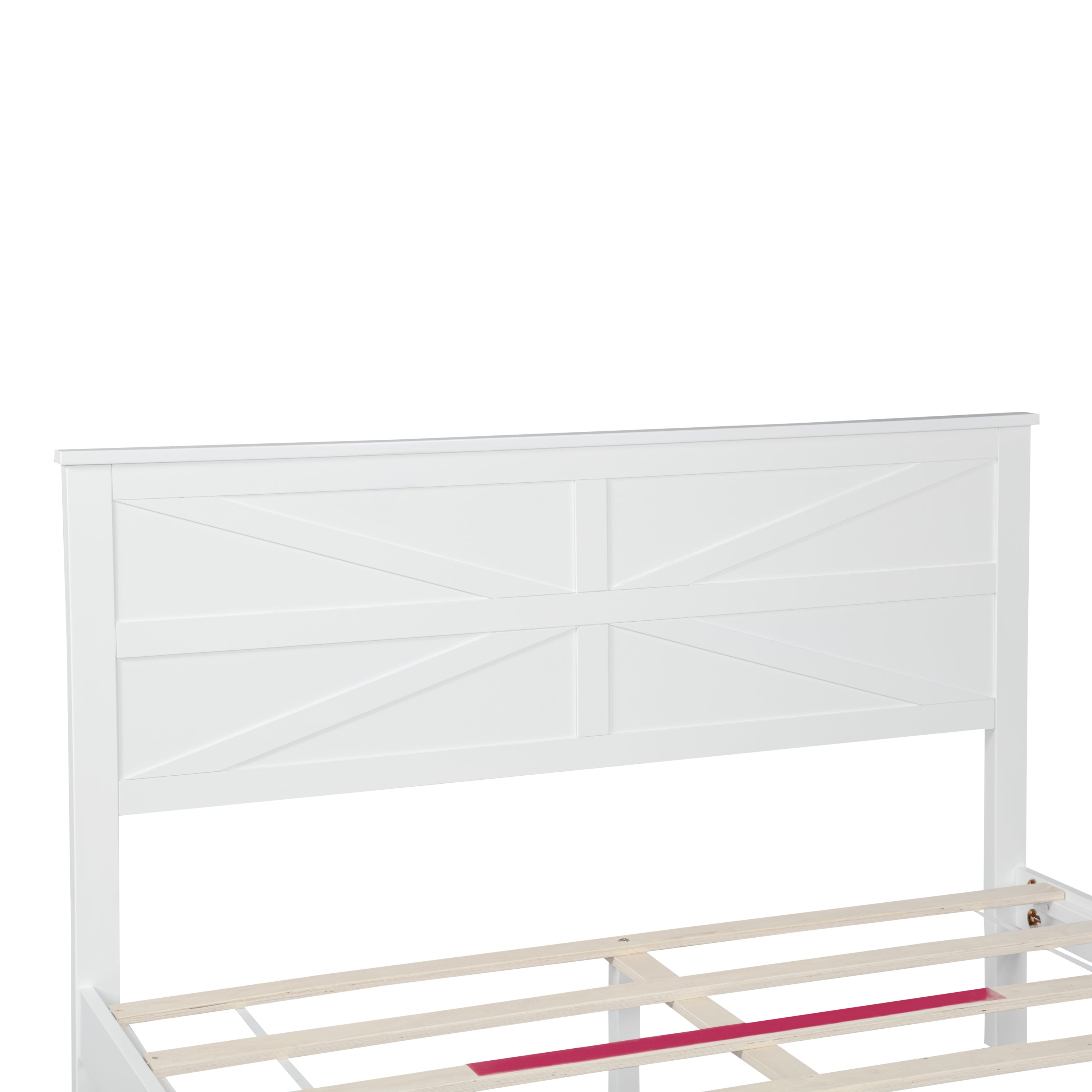 Close-up of the white headboard barn-door X-panel above the exposed slats