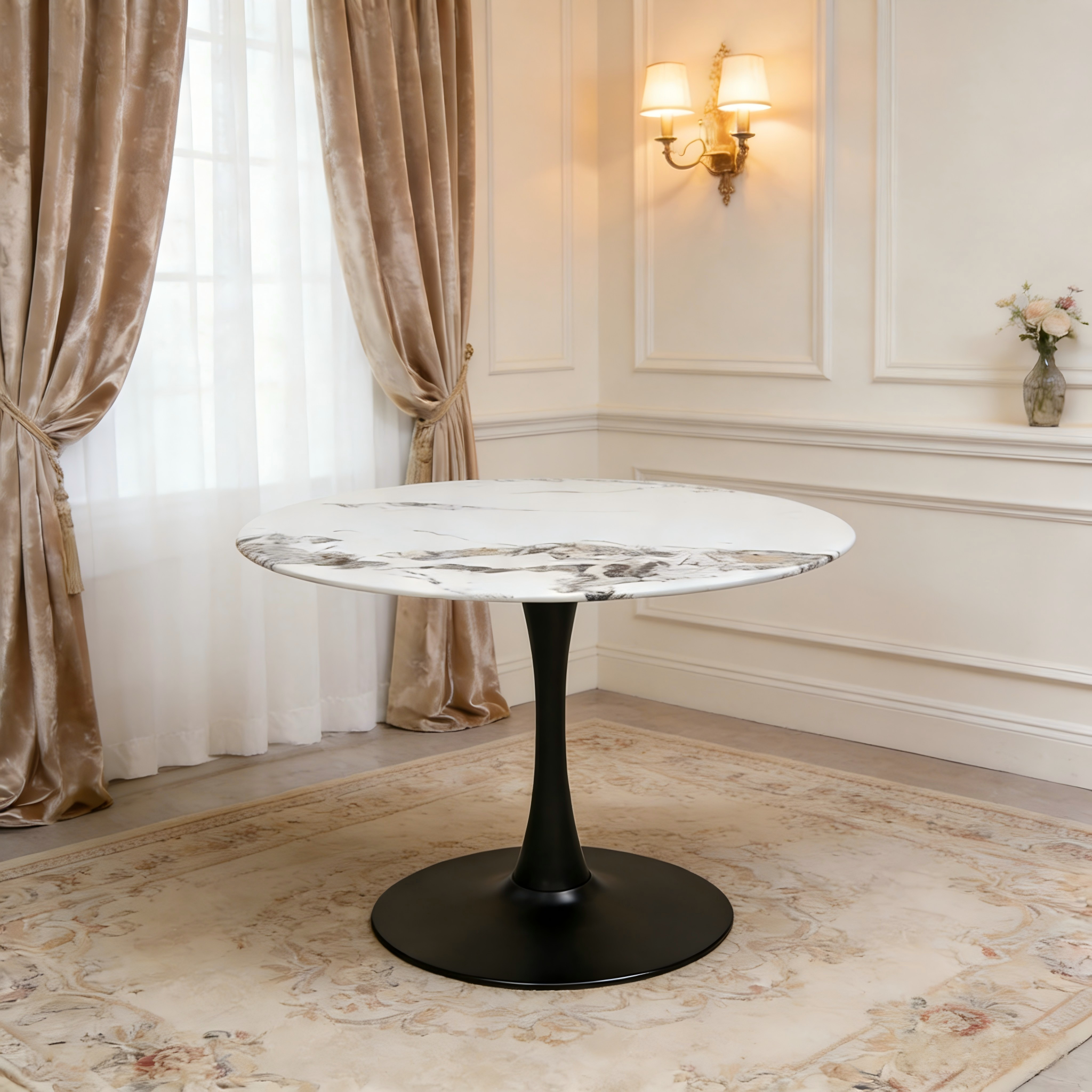 Front view of the white faux marble tulip table in an elegant room with a wall sconce
