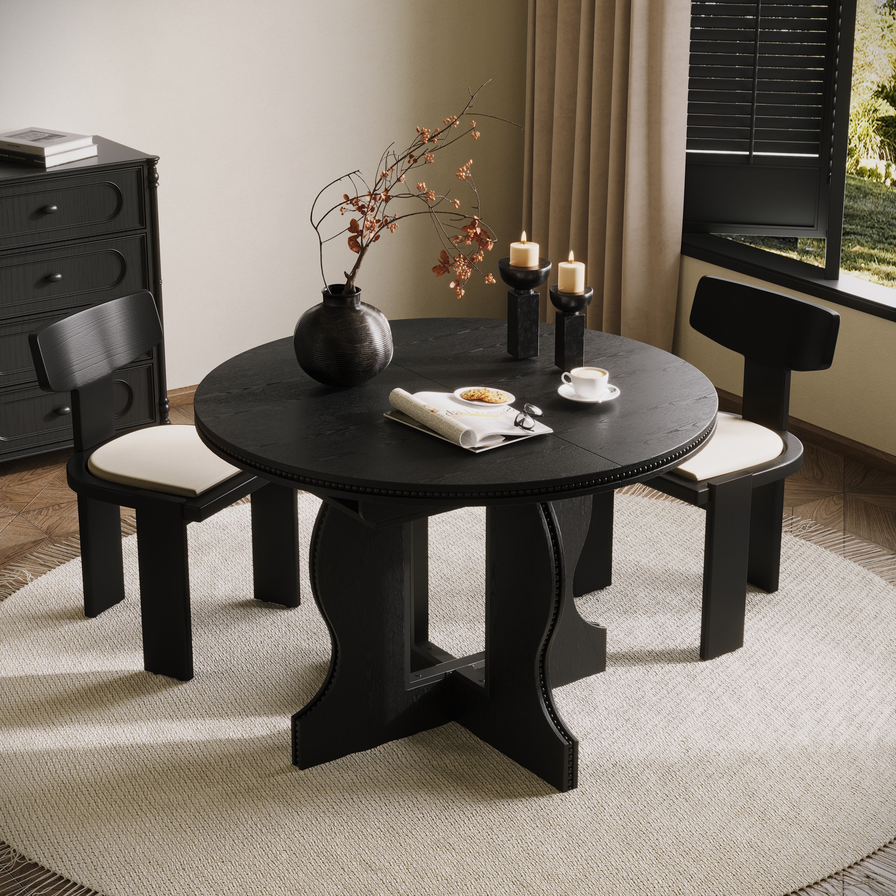 Black round pedestal dining table in its round form, overhead angle in a styled dining room with two black chairs