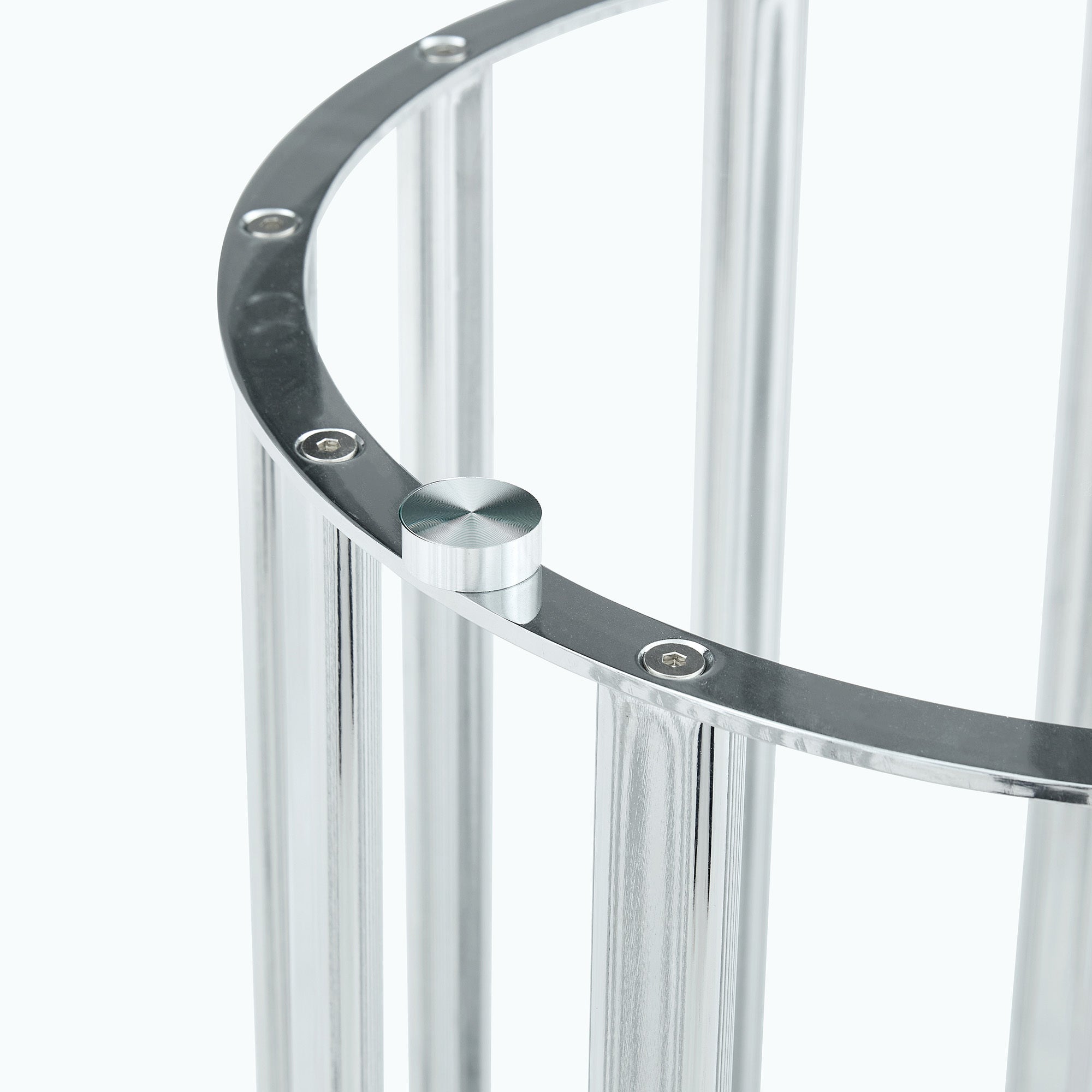 Close-up of a metal suction cup on the silver ring that grips the glass tabletop.