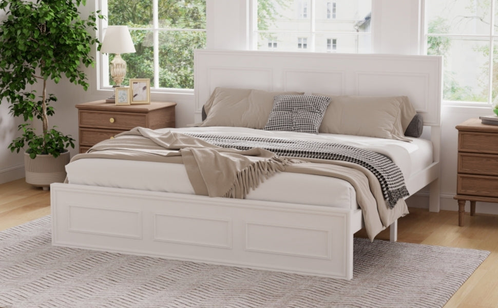 Corner view of the white panel queen bed with headboard and footboard beside a wood dresser and plant #Color_White