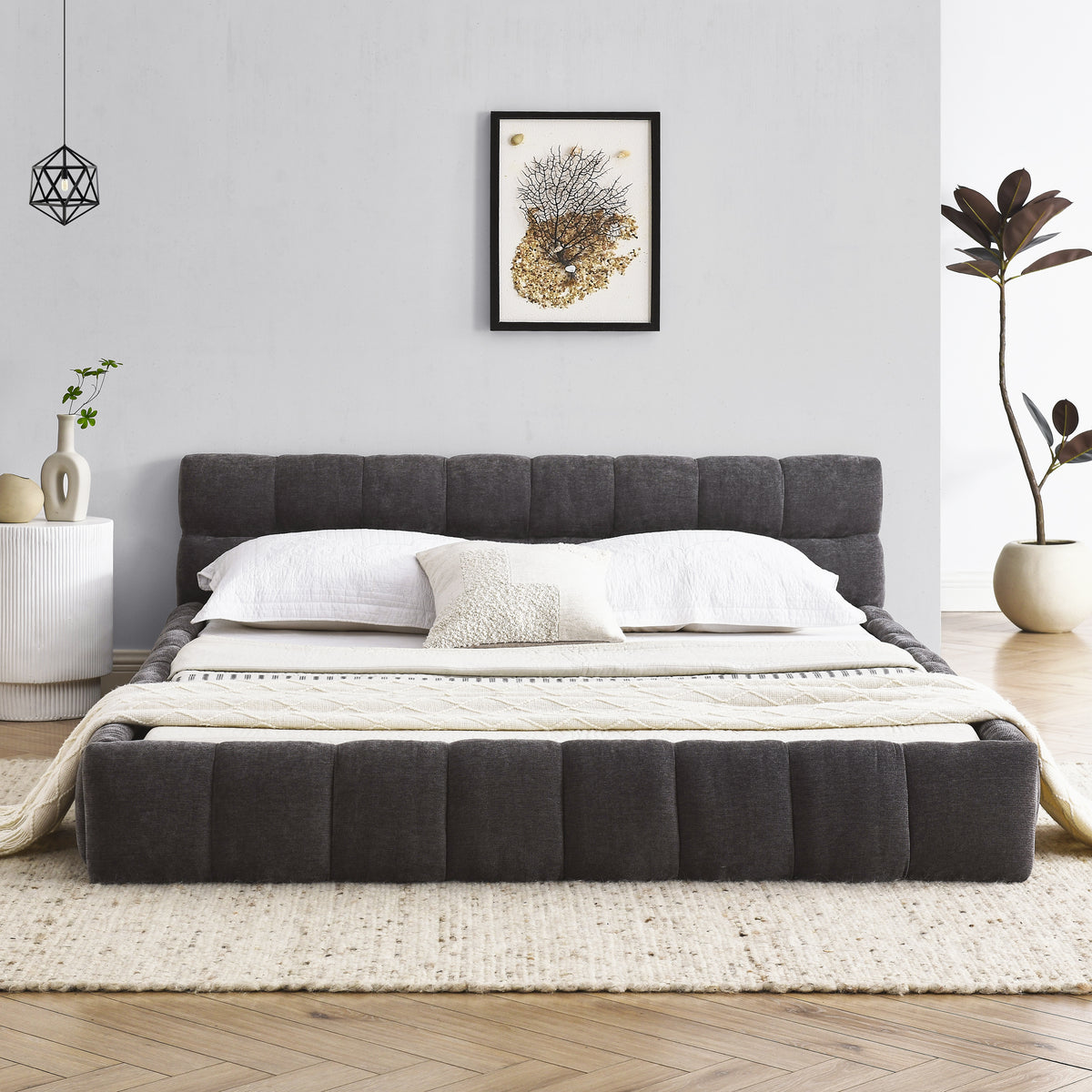 Dark grey chenille platform bed styled in a bedroom, angled foot view with white bedding