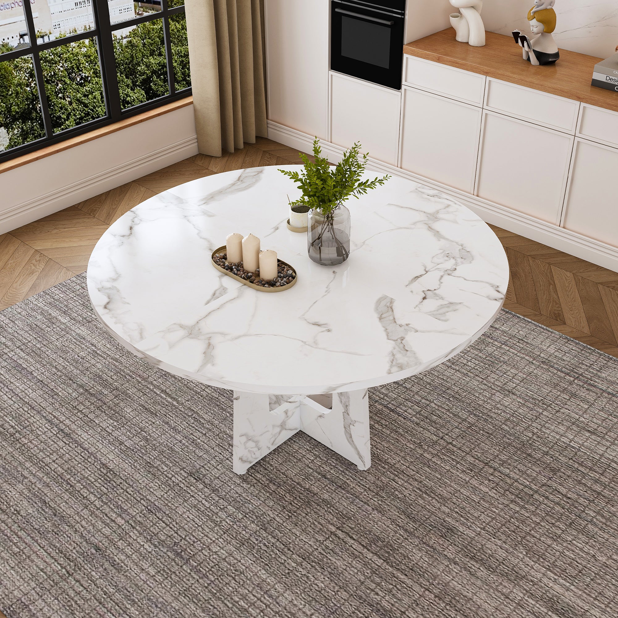 Overhead view of the white faux marble round dining table on a rug in a bright room