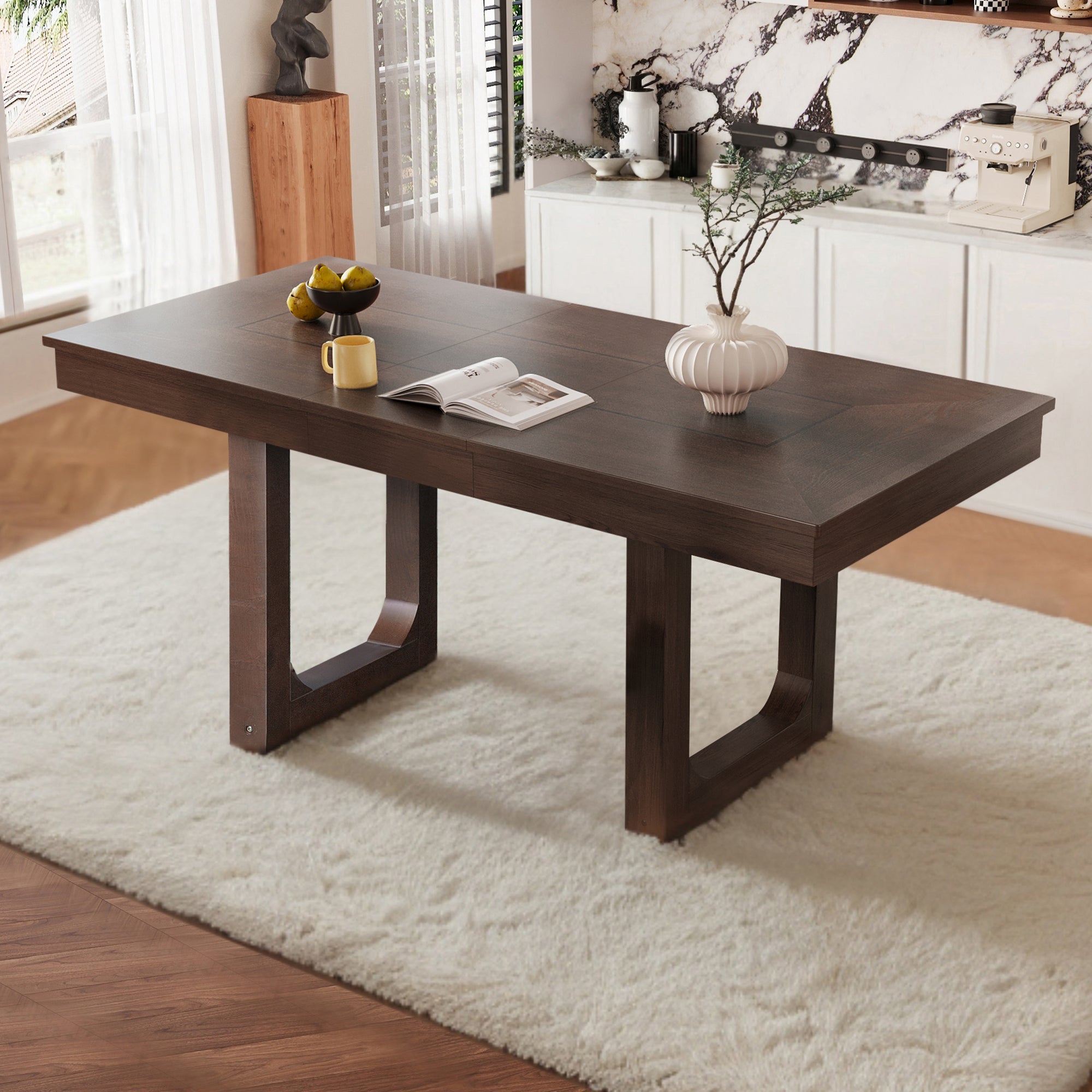 Three-quarter view of walnut farmhouse extendable dining table styled in a bright kitchen on a plush white rug
