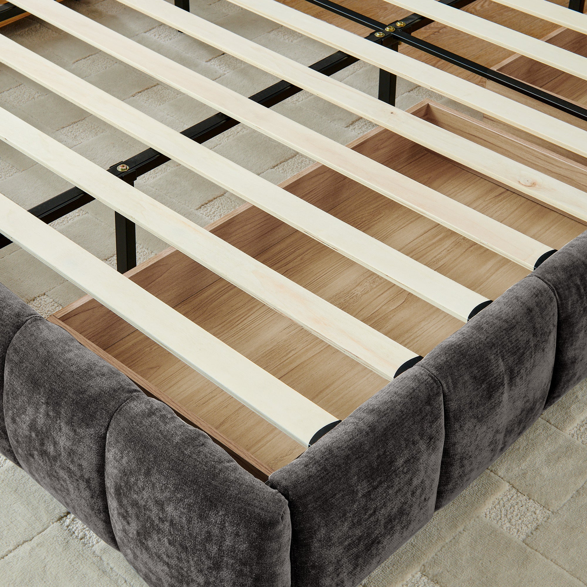 Dark gray king bed frame with two drawers open, side angle