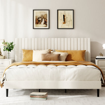 Close-up of channel-tufted beige velvet headboard behind styled pillows