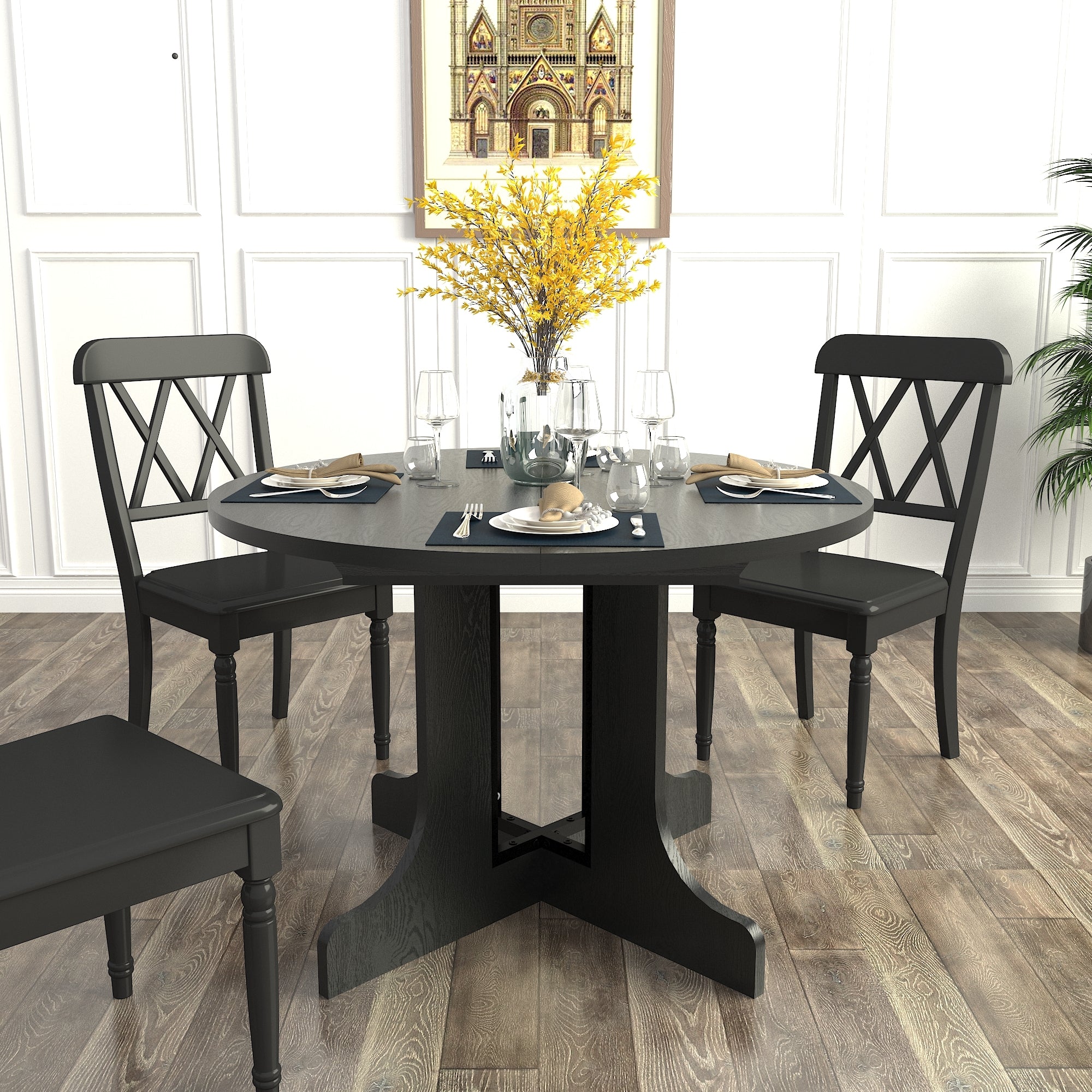 Black oval dining table set for six with forsythia centerpiece and cross-back chairs by a window
