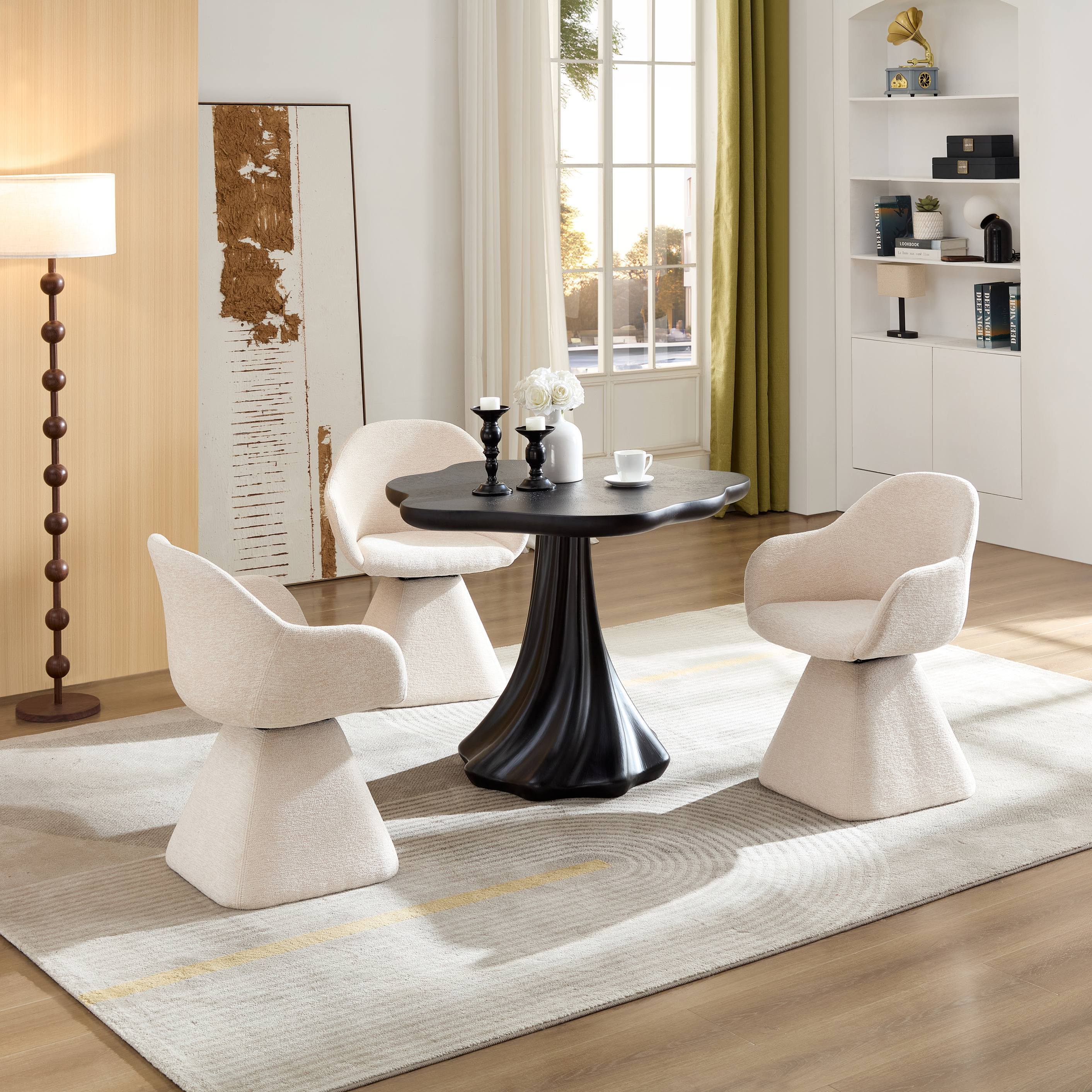 Black petal dining table set with three cream boucle chairs in a bright styled living room