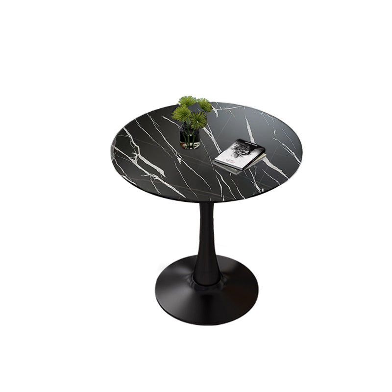 Plain studio three-quarter view of black faux marble round pedestal bistro table
