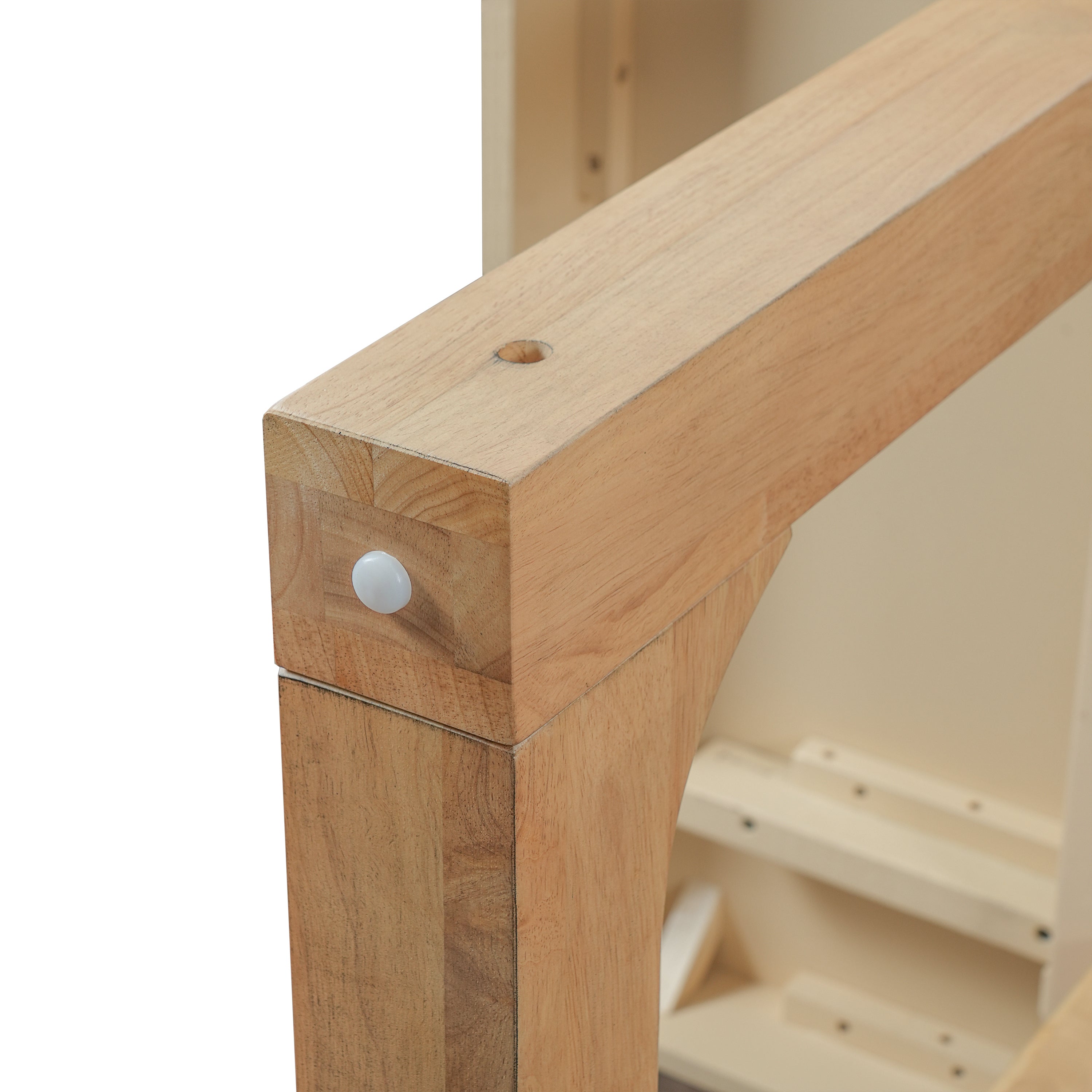 Close-up of a leg joint with white cap and dowel hole on the oak dining table frame
