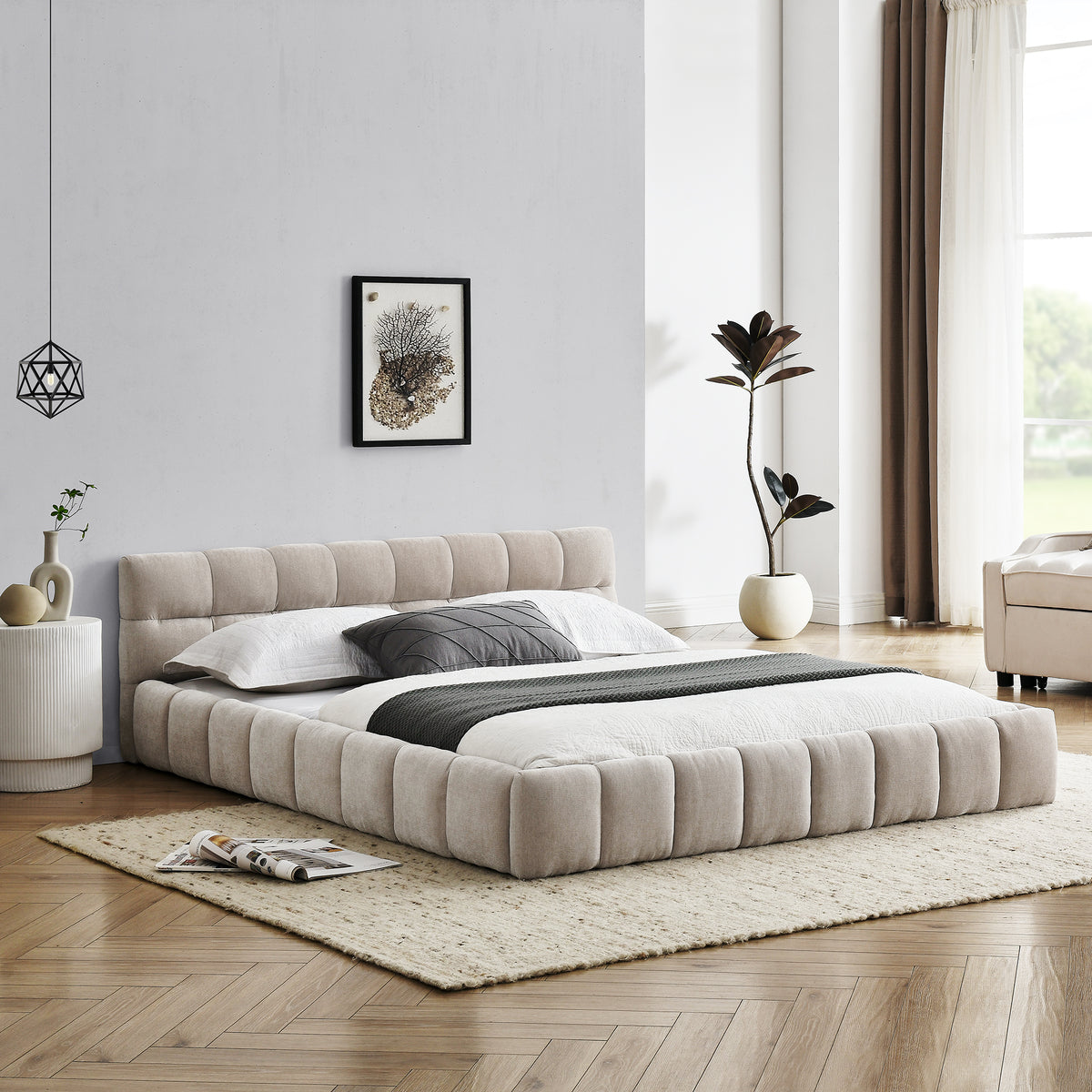 Beige chenille platform bed viewed head-on from the foot, made up in a styled bedroom