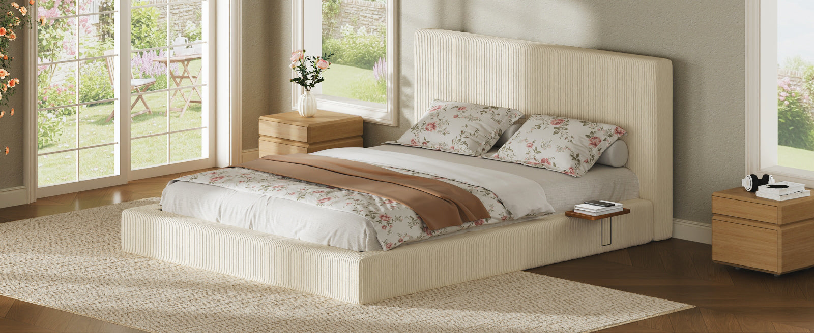 Cream corduroy queen platform bed with floral bedding by a garden window, books on the wood side shelf
