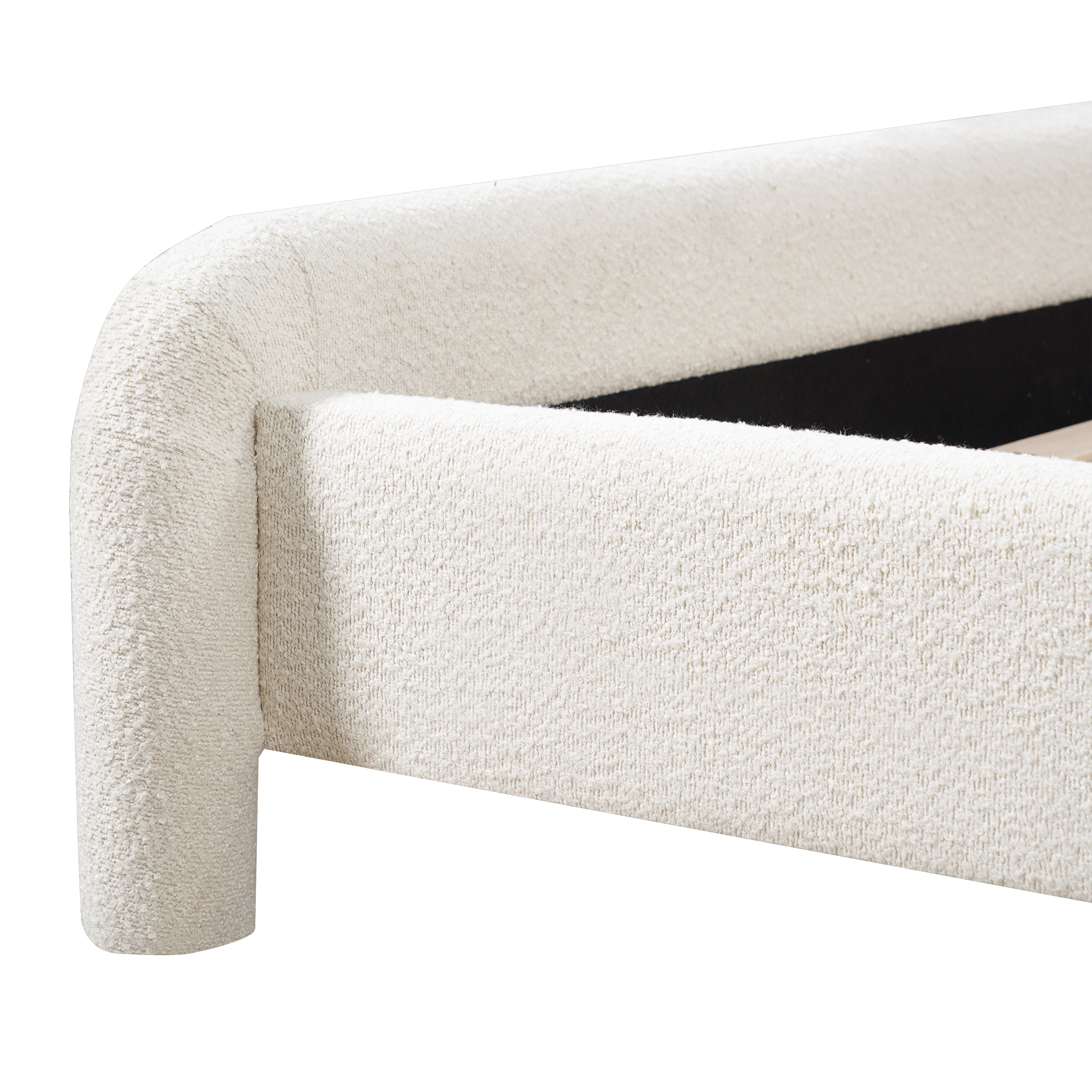 Close-up of rounded footboard corner and leg on boucle bed frame