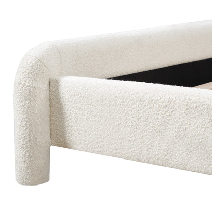 Close-up of rounded footboard corner and leg on boucle bed frame