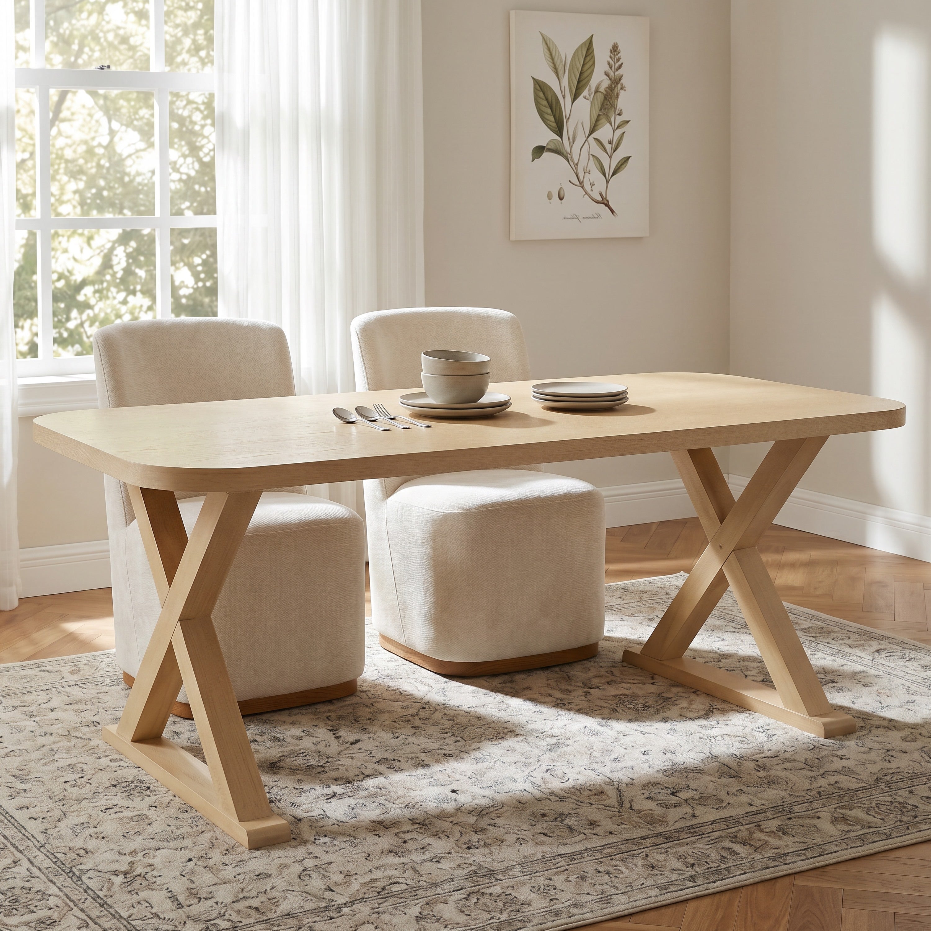 Natural oak dining table with X-legs styled in a bright room with cream boucle chairs and ottomans
