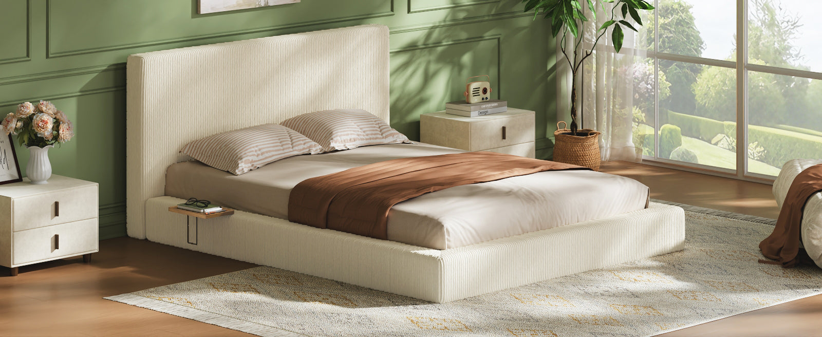 Cream corduroy queen platform bed against a green wall, glasses and books on the sliding wood shelf
