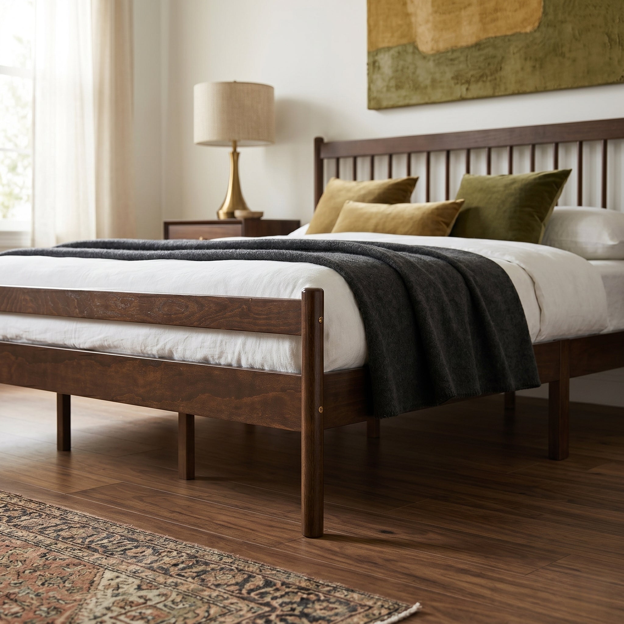 Close-up of walnut headboard and footboard with olive pillows