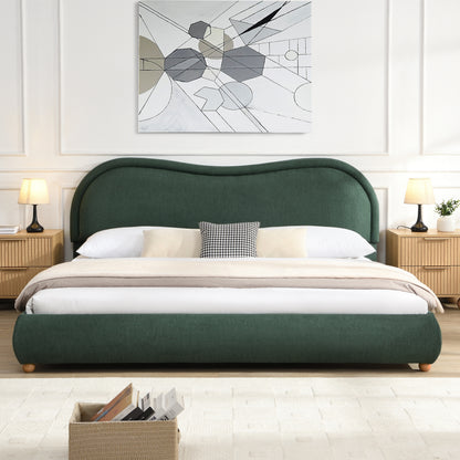 Olive green king bed in bedroom with abstract art and wood nightstands