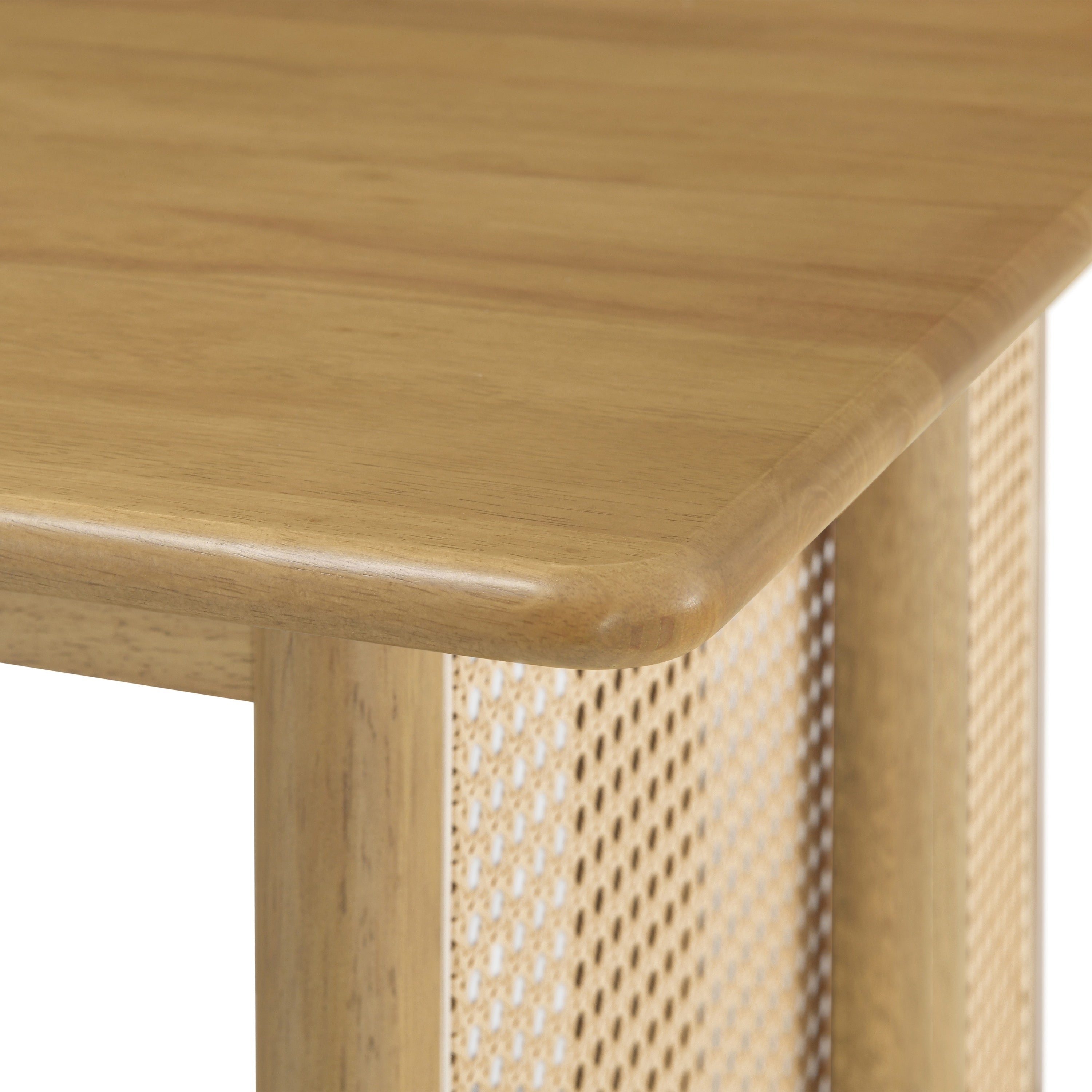 Close-up of a tabletop corner meeting the woven cane panel leg, plain white background