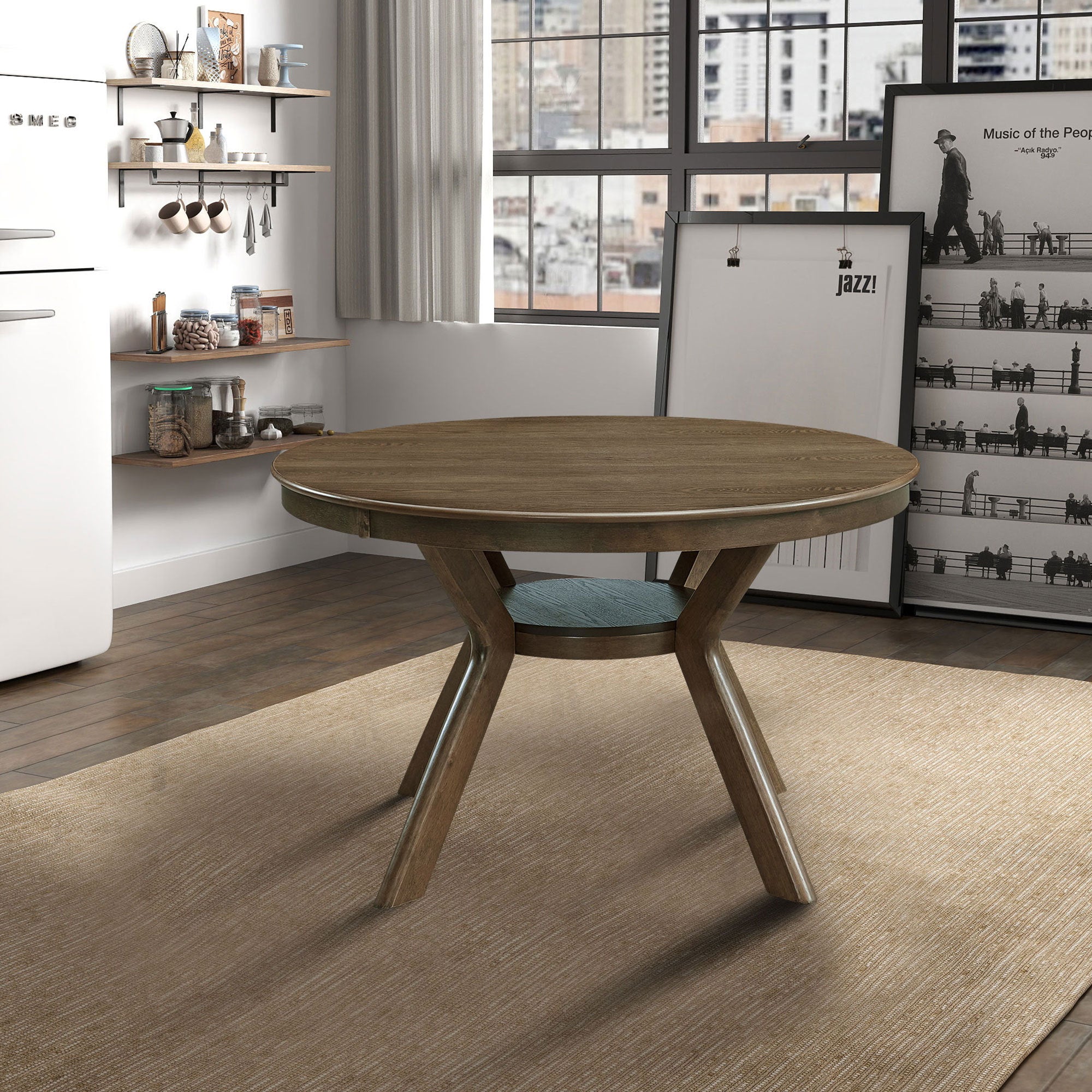 Round oak-tone dining table with crossed splayed legs, styled in a modern kitchen with open shelving