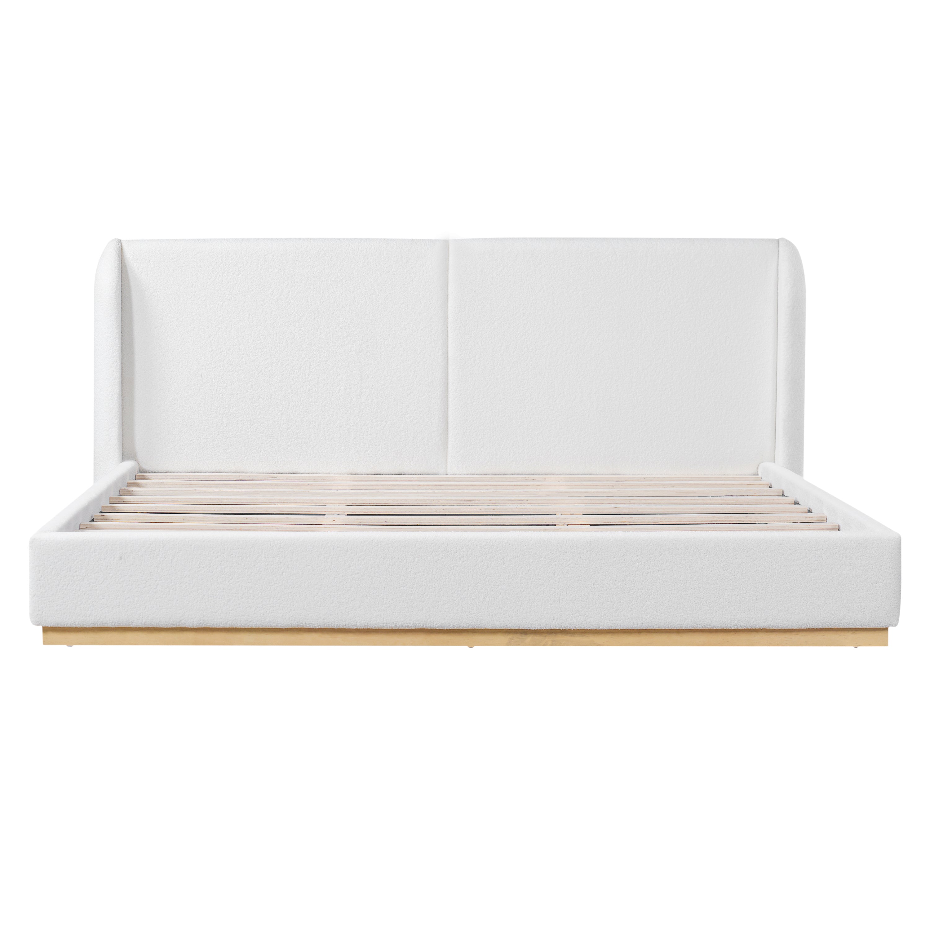 White bouclé king bed frame styled in a bedroom with abstract wall art