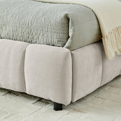 Close-up of drawer caster wheel and beige chenille side panel