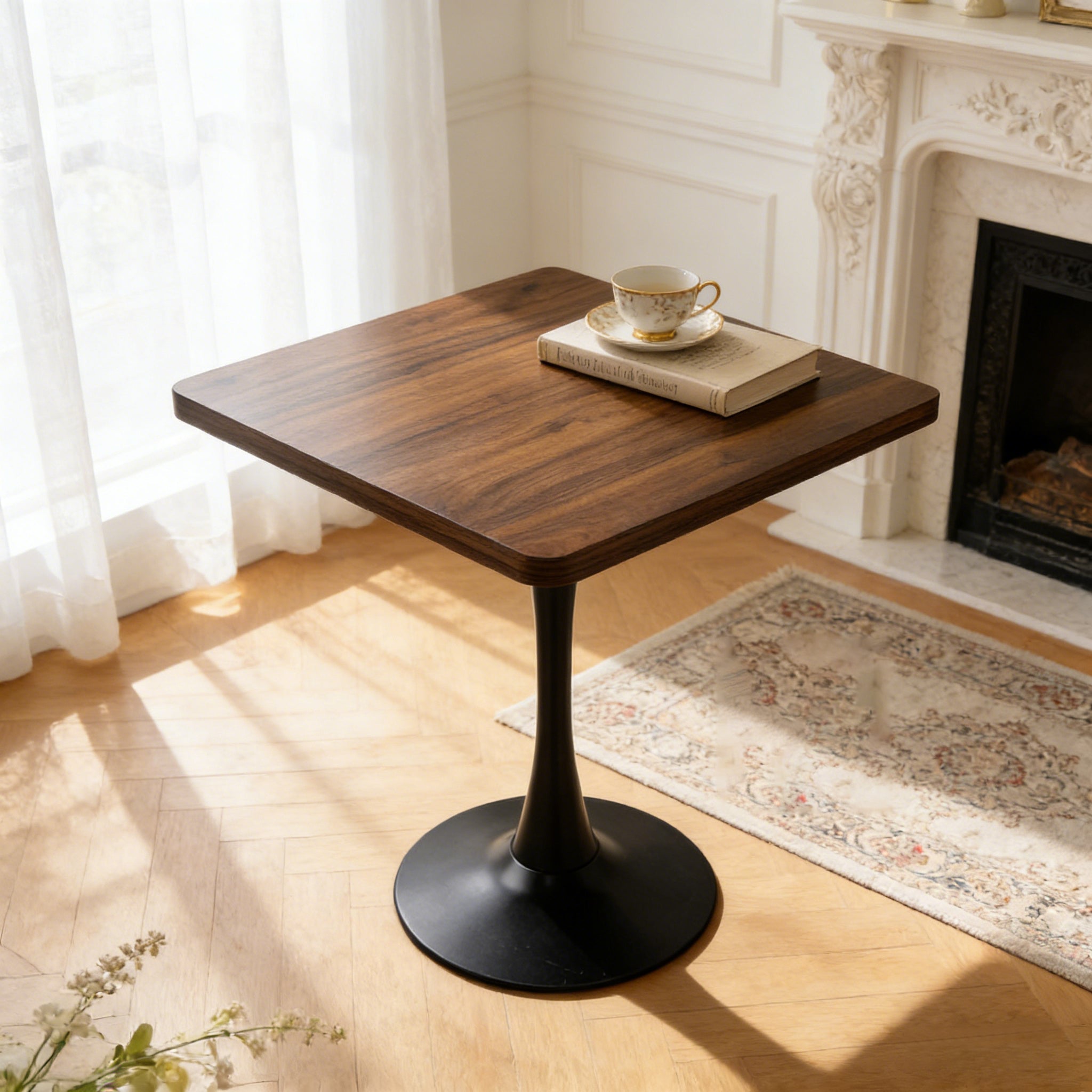 Walnut square tulip dining table by a fireplace and sheer curtains, teacup and book on top