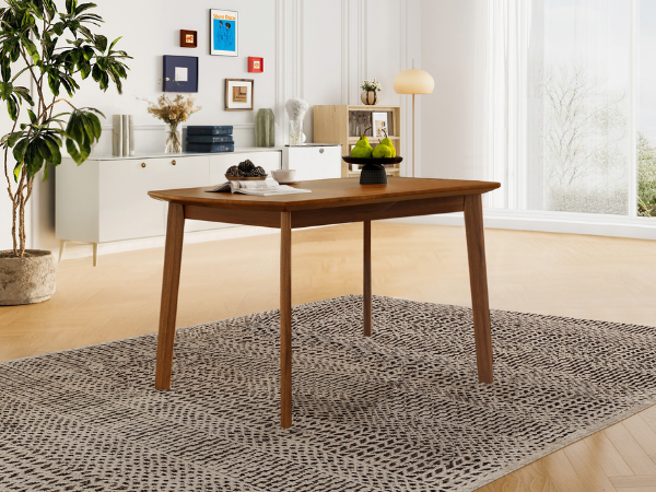Brown mid-century dining table styled with a berry bowl beside a plant and white sideboard