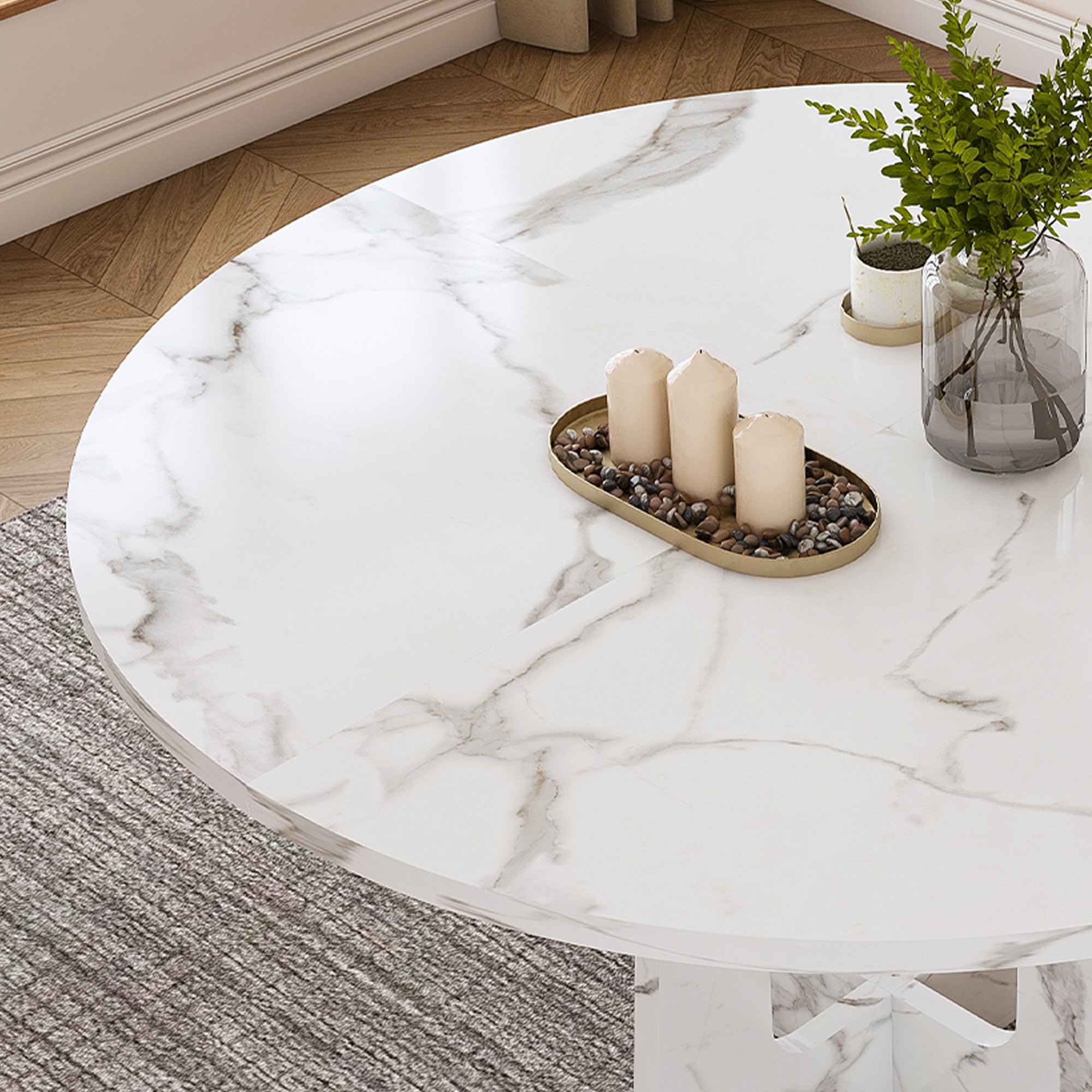 Overhead close-up of the white faux marble tabletop with a candle tray and plant