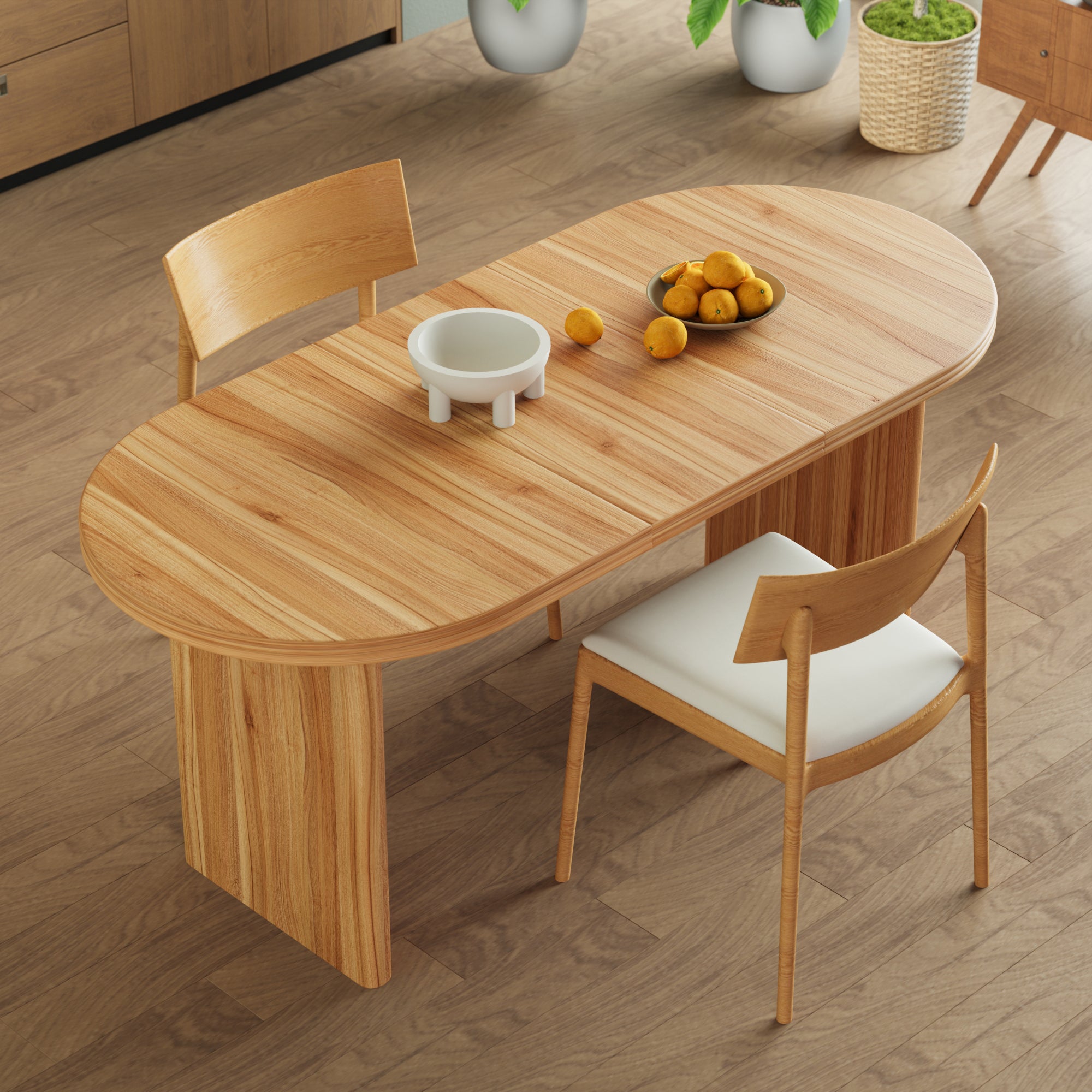 Overhead view of the closed walnut-tone oval table with wood chairs around it